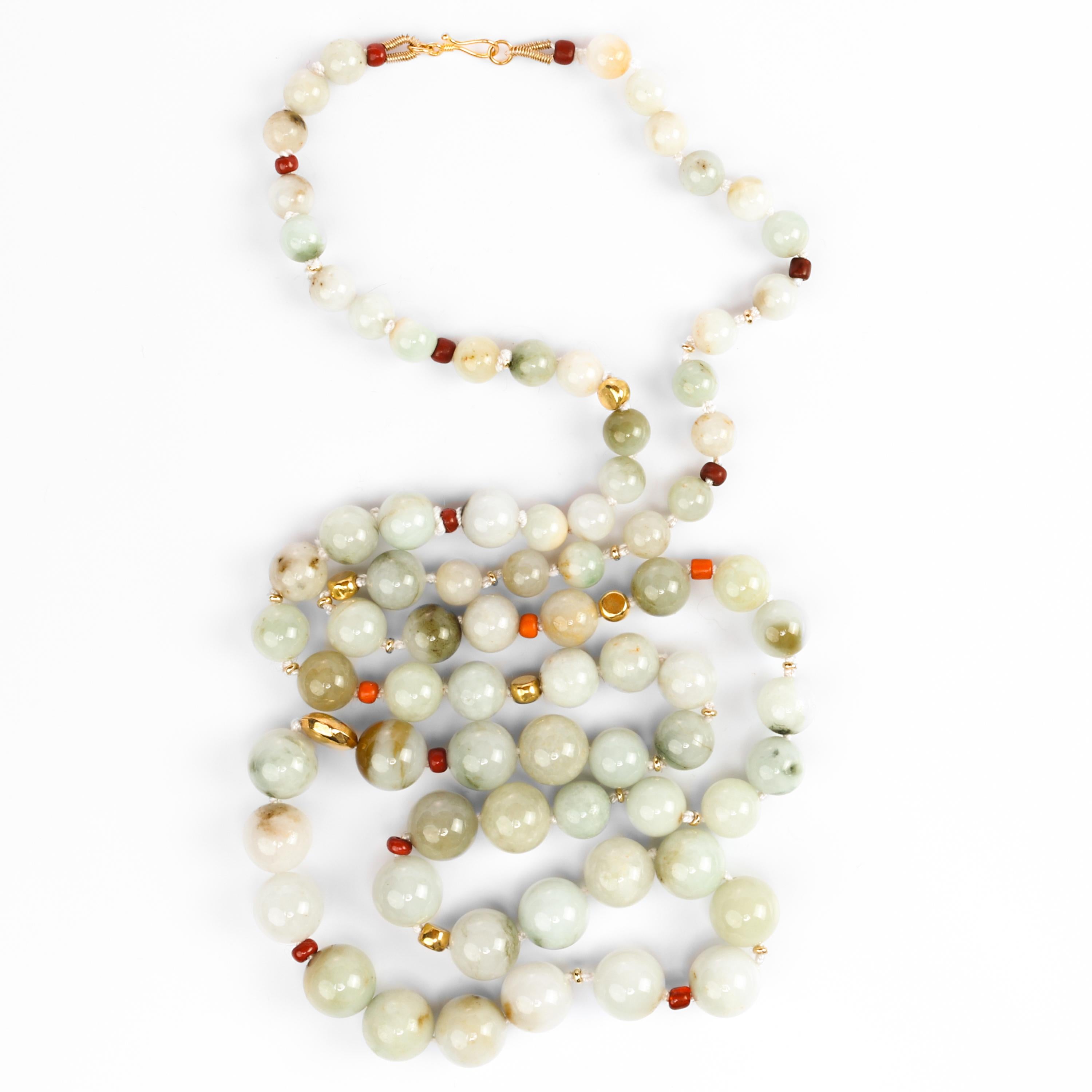 This fun and elegant handmade necklace is composed of 76 certified untreated Burmese jadeite jade beads strung and knotted on silk and punctuated with vintage red glass or clay beads and 18K yellow gold beads of different sizes and shapes. The