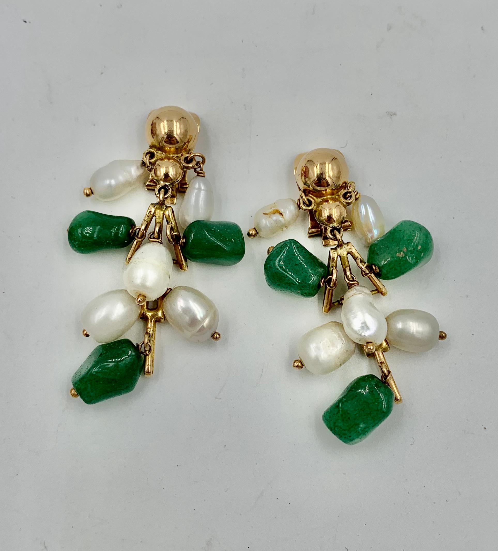 A delightful pair of Jade and Pearl Drop Dangle Earrings in 14 Karat Yellow Gold.  The retro earrings have articulated sections in 14 Karat Gold with Green Jade and Pearls hanging from the gold.  The earrings have wonderful movement and delightful