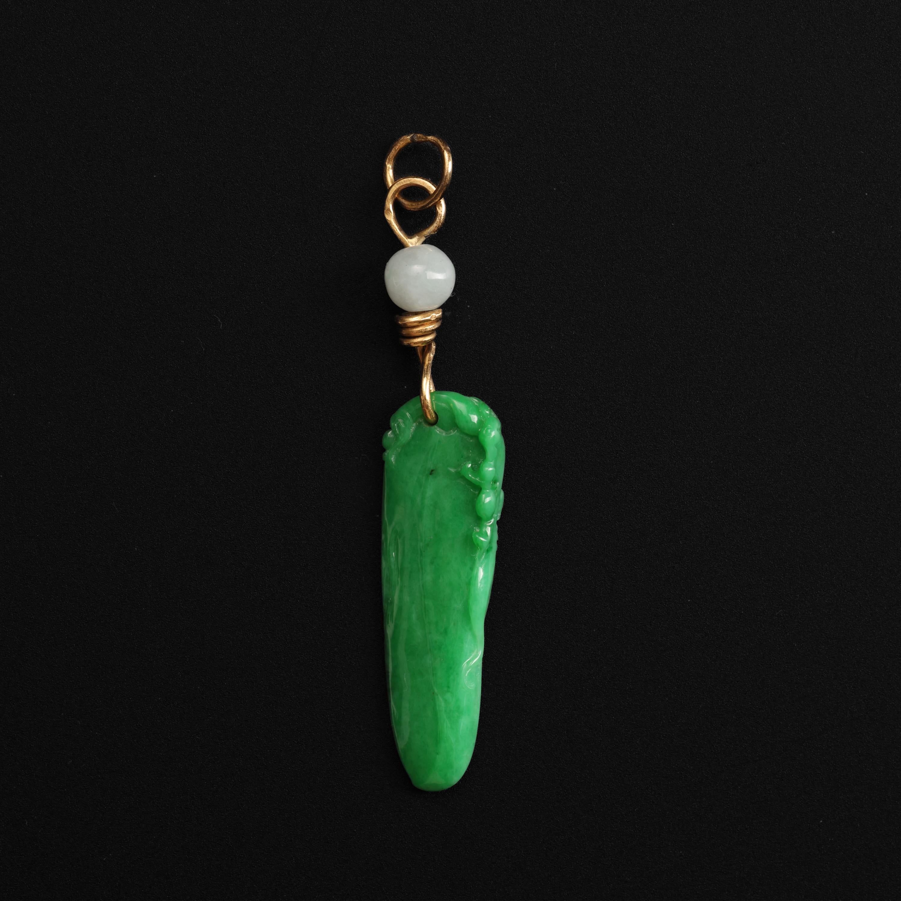 This jade pendant was hand-carved by a master lapidary artist with unusual natural and untreated jadeite jade from Burma. I say unusual because the color is vividly intense. As a gemologist myself and a second-generation collector of jade, I pride
