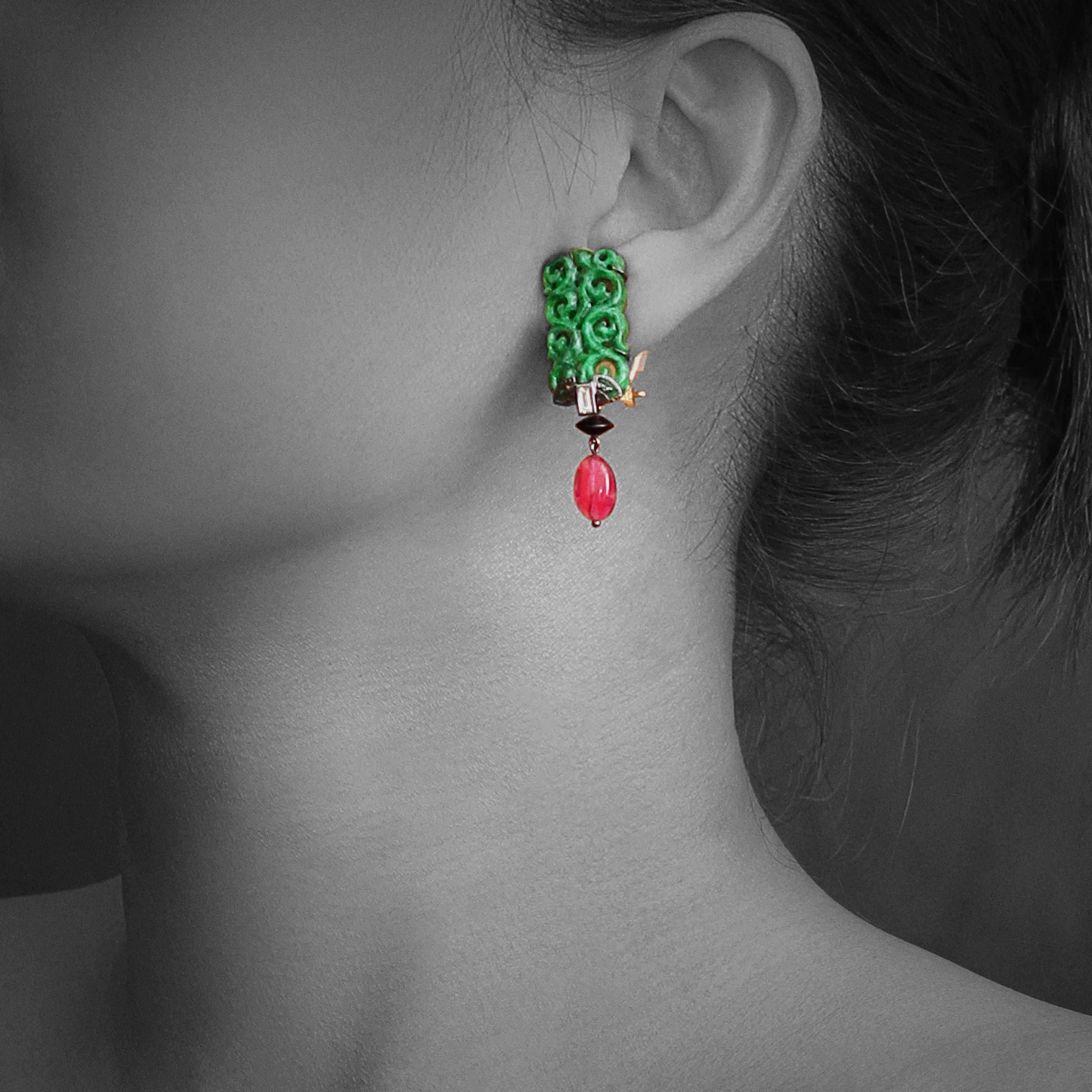 Refined hand-crafted jade earrings.
  wt. 14.91 g.
Our designers have selected carved green jades to complement baguette diamonds, mounted in sterling silver black rhodium plated, glass beads and rubelite drops.
Dimension: 4.4x1.4x0.7 cms. 
The pins