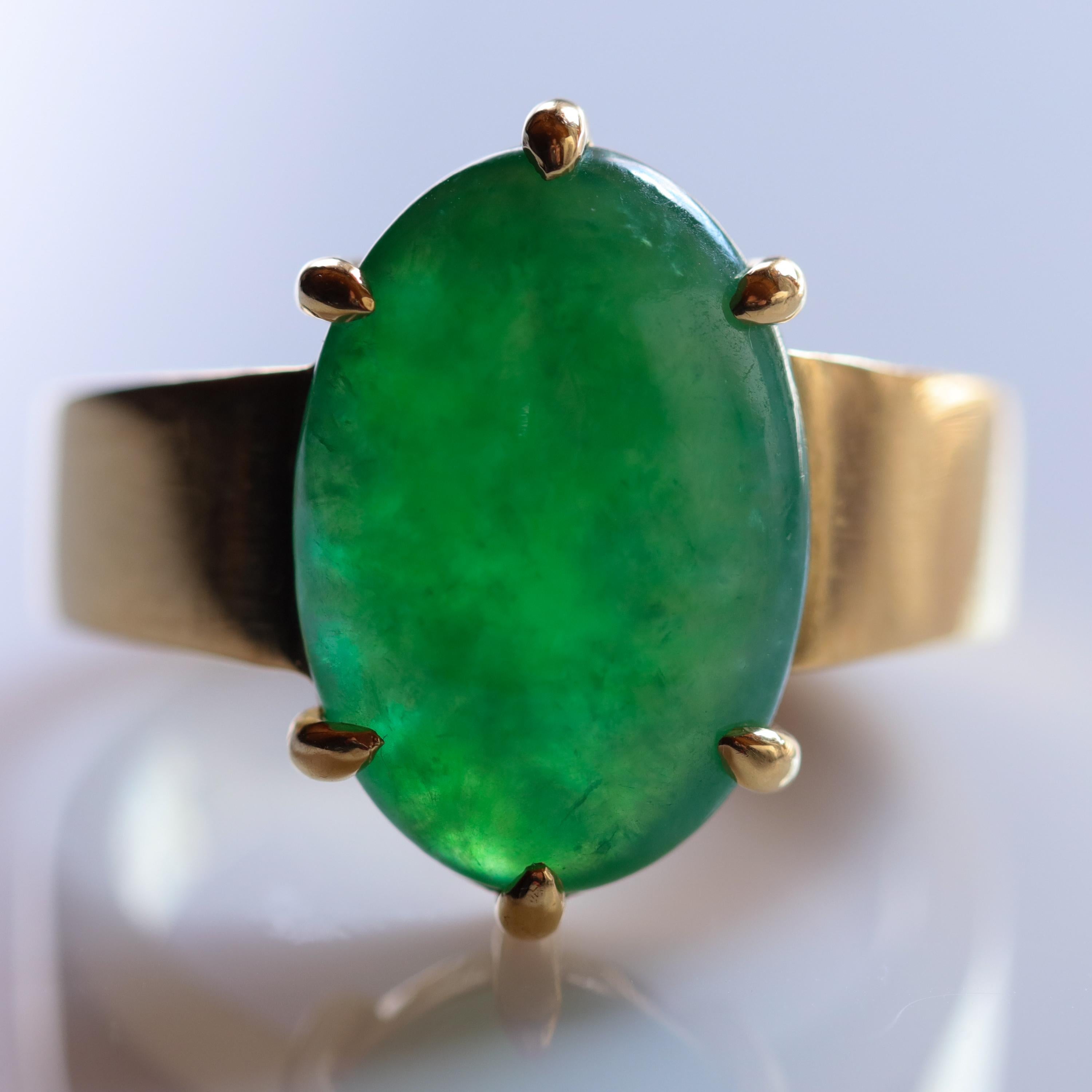 A fine emerald-green Burmese jadeite jade cabochon glows imperially from within its thick, heavy solid 22K gold setting. Six thick claws hold the luminous jade cabochon in place. This magnificent and exceedingly rare jade ring is so extraordinary,