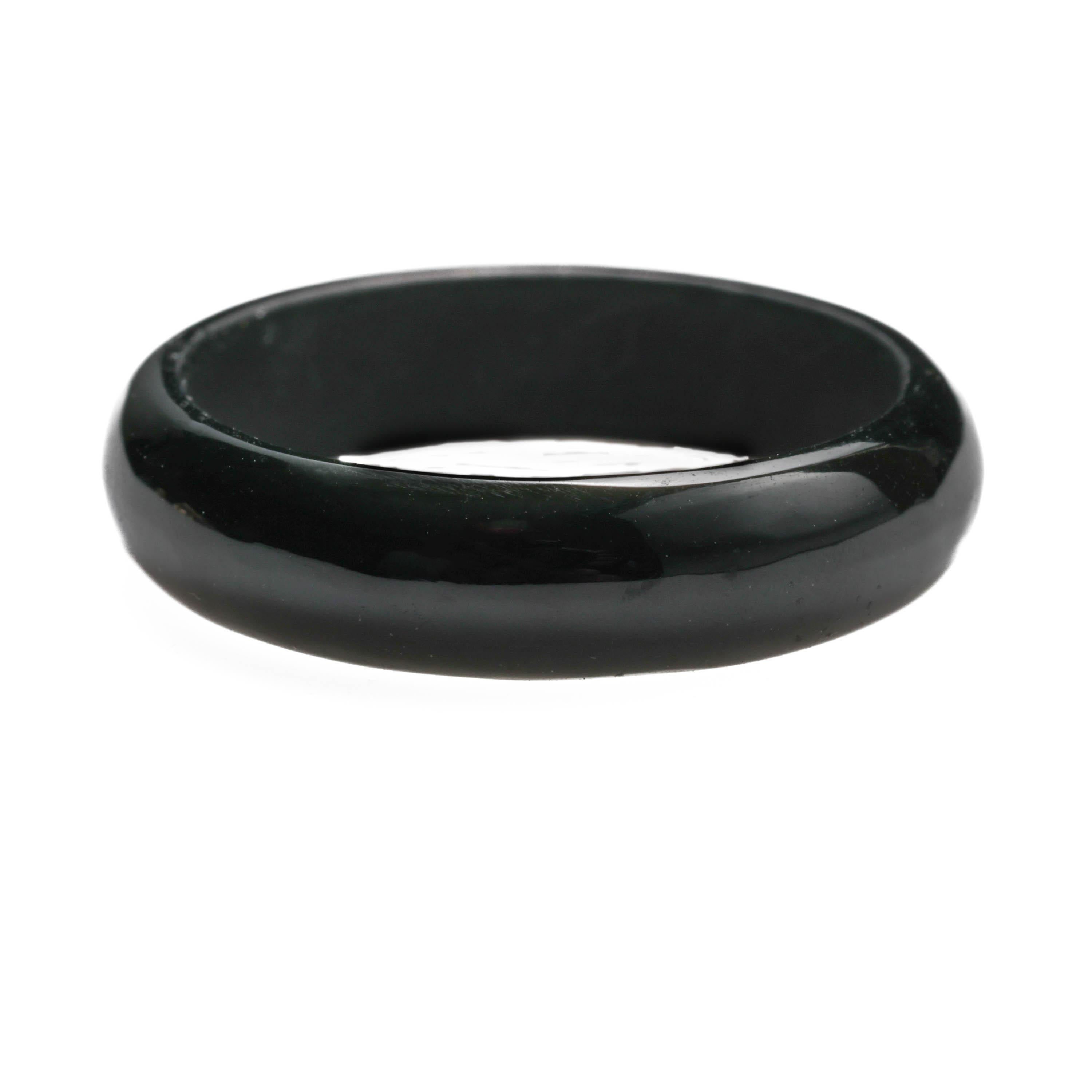 This ring was carved from a single piece of certified natural and untreated black nephrite jade. The gleaming grand piano polish creates a circle white light all the way around the band. Dirty little secret: the vast majority of black jade has been