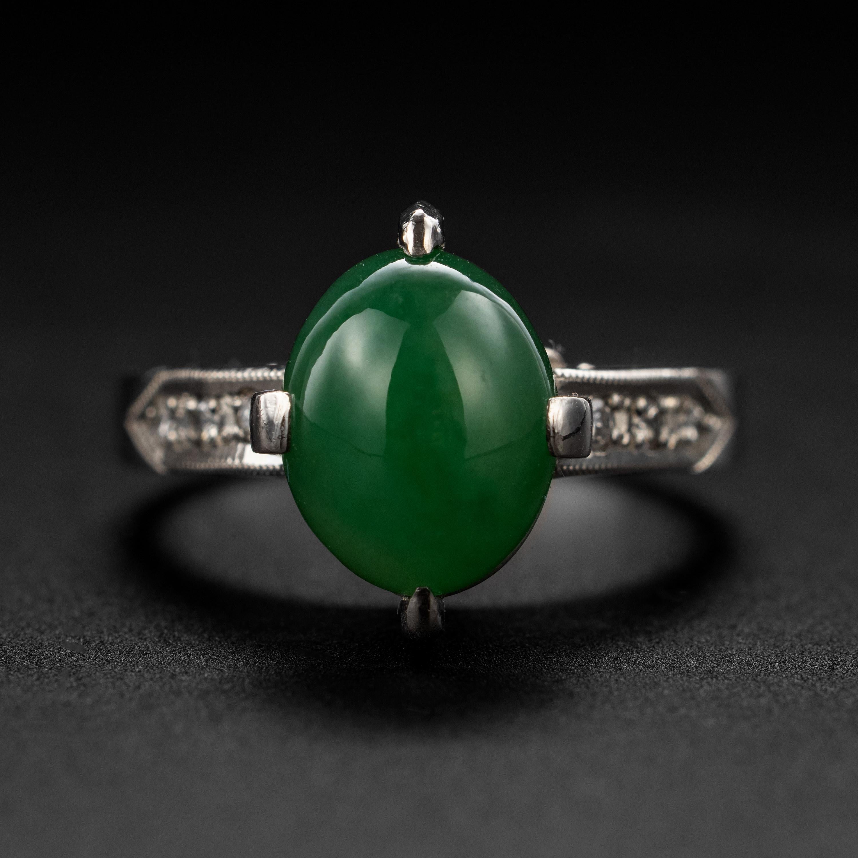 This Jade Ring & Diamond Ring in Platinum is iconic.

A beautifully simple and classic jade solitaire ring from the 1950s. Featuring a lush emerald-green cabochon of jadeite jade that has been GIA-certified natural and untreated, this stunning ring