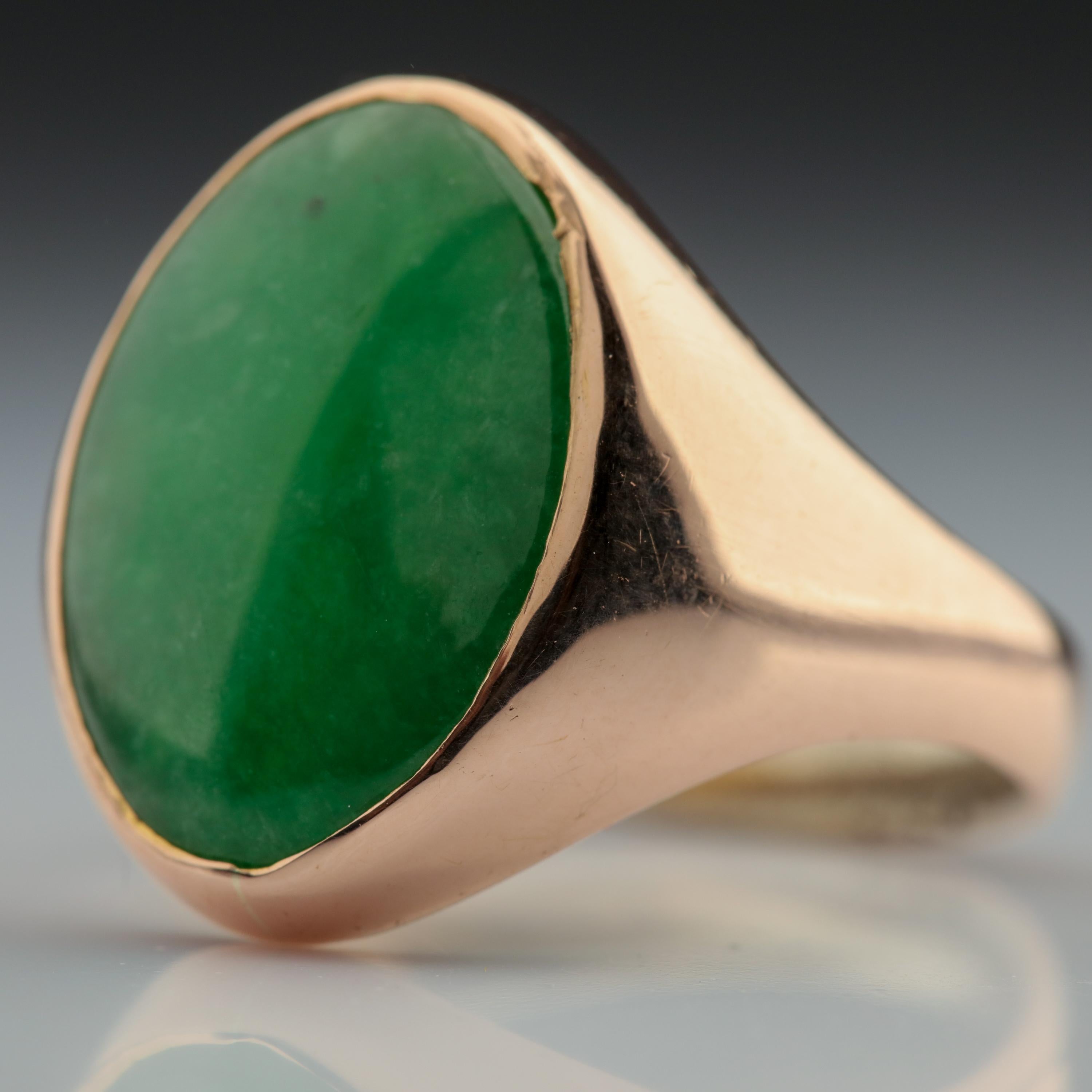 A beautiful, saturated cabochon of 100% natural and untreated jadeite jade is simply presented in this classic rose gold setting from the Retro era of the 1940s. The jade is a deep, evenly-toned forest-green that features a gleaming high-polish. The