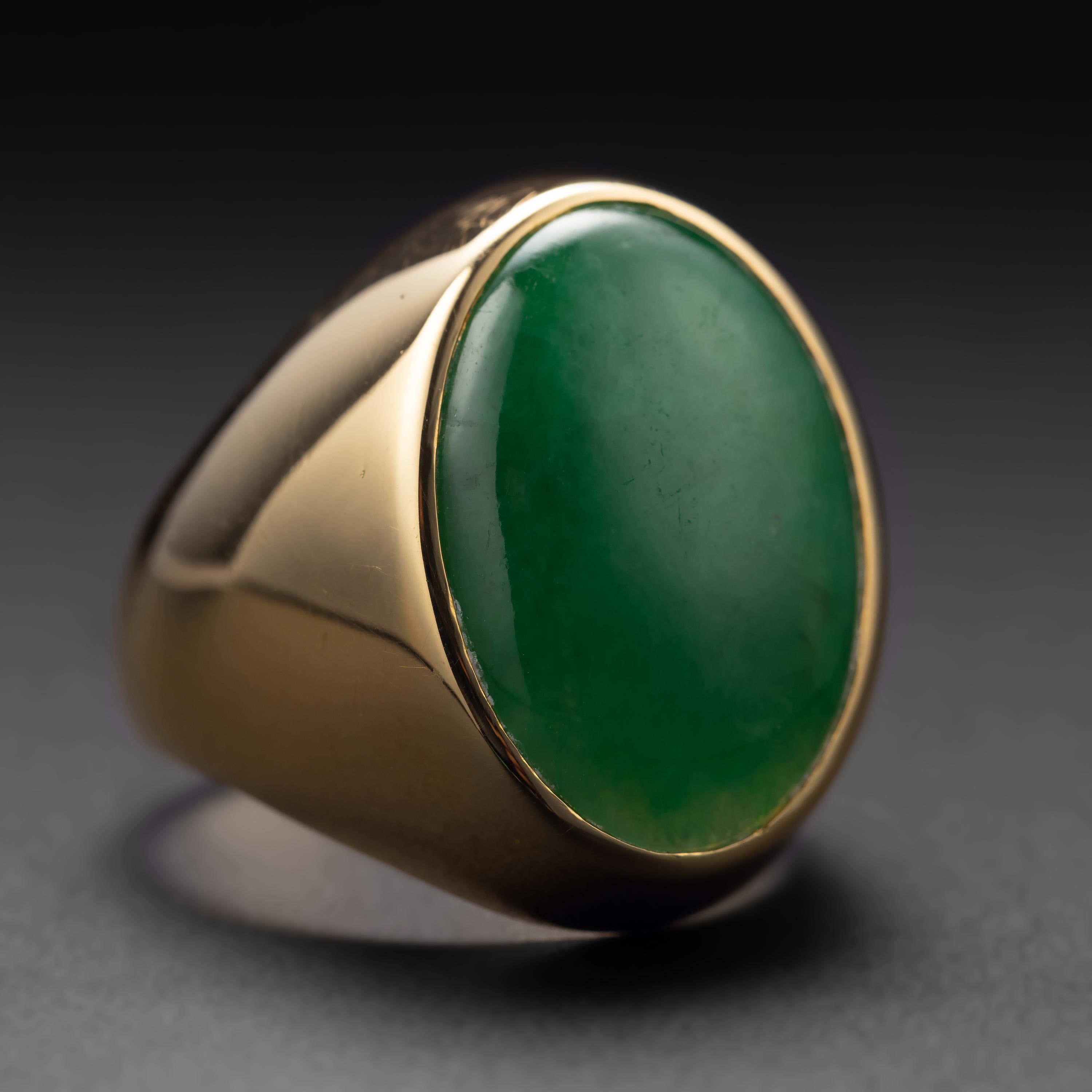 Rare and impressive: this substantial and beautiful jade ring from the 1950s was crafted by hand from rich 18K yellow gold and features large cabochon of natural and untreated Burmese jadeite jade. The jade stone measures a sizeable 13.90 x 19.90mm