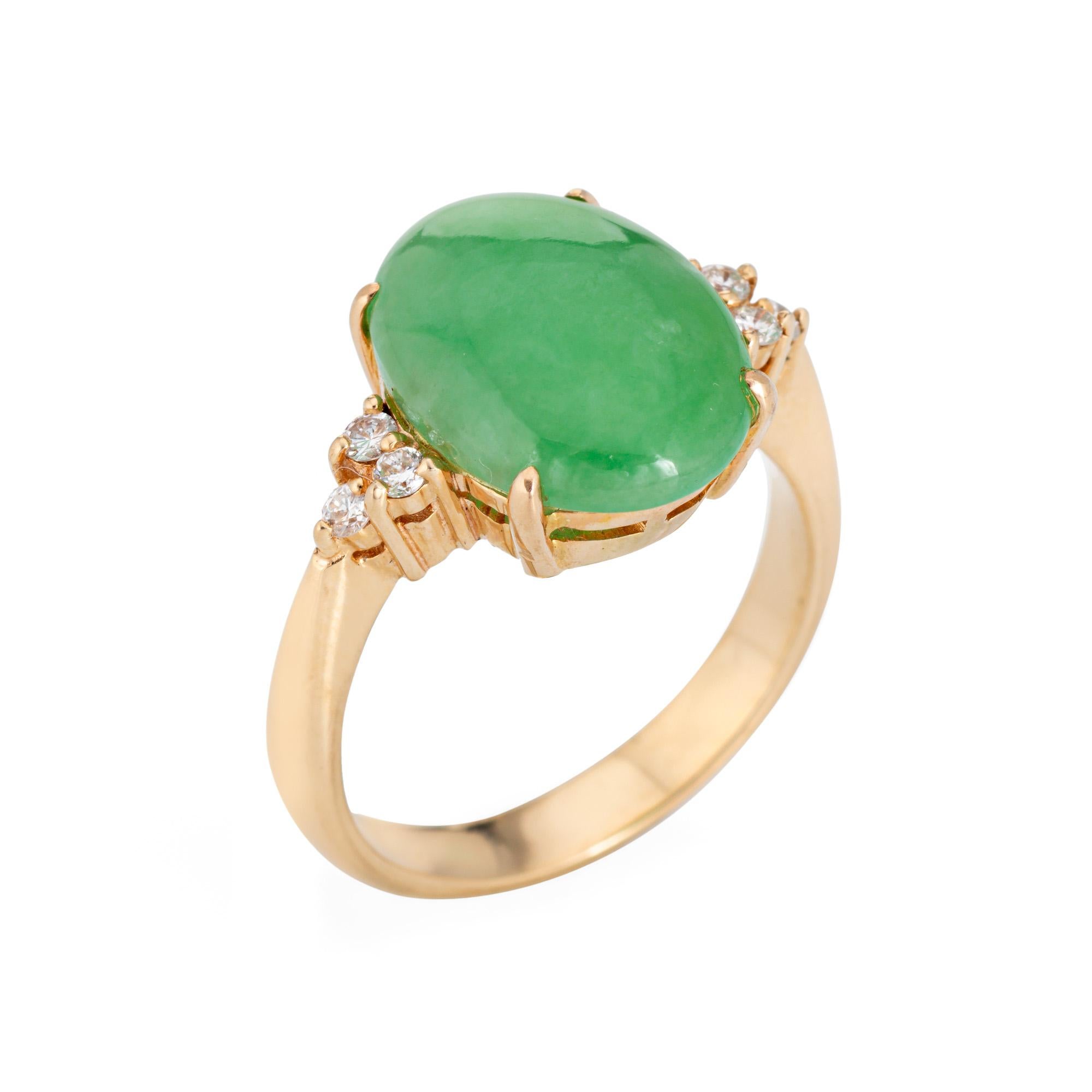 Stylish vintage jade ring (circa 1960s to 1970s) crafted in 14 karat yellow gold. 

Jade measures 14mm x 10mm. The jade is in good condition and free of cracks or chips. Six diamonds total an estimated 0.06 carats (estimated at H-I color and VS2-SI2