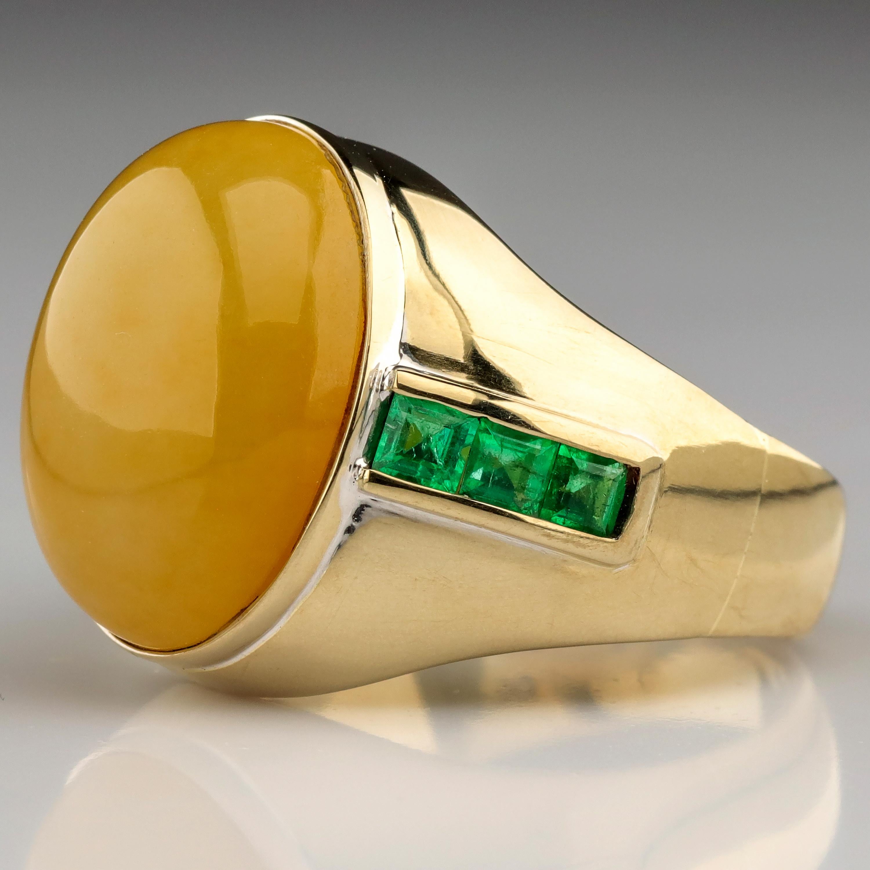 A yellow jade ring with Colombian emeralds is not a ring you see every day. But what an excellent and handsome combination it is.

Evenly-toned, finely-grained and highly translucent orangy-yellow jade is among the rarest gemstones on earth. Green