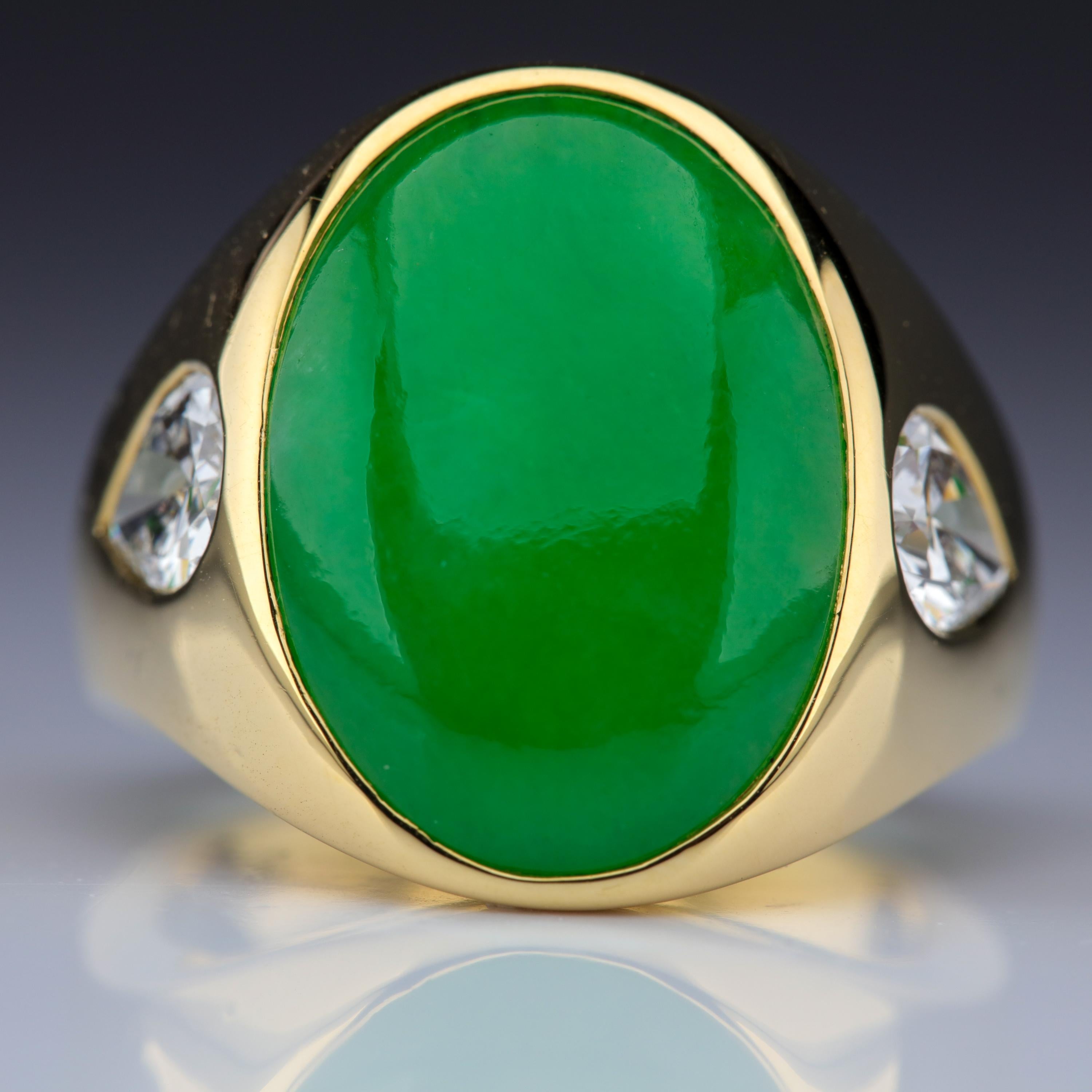 This spectacular and rare 18k yellow gold ring features a large (19.1 mm X 13.8 mm X 3.90 mm) natural and untreated Burmese jadeite jade cabochon of vivid apple-green coloring and high translucency —a superb, old-mine stone. A pair of white and