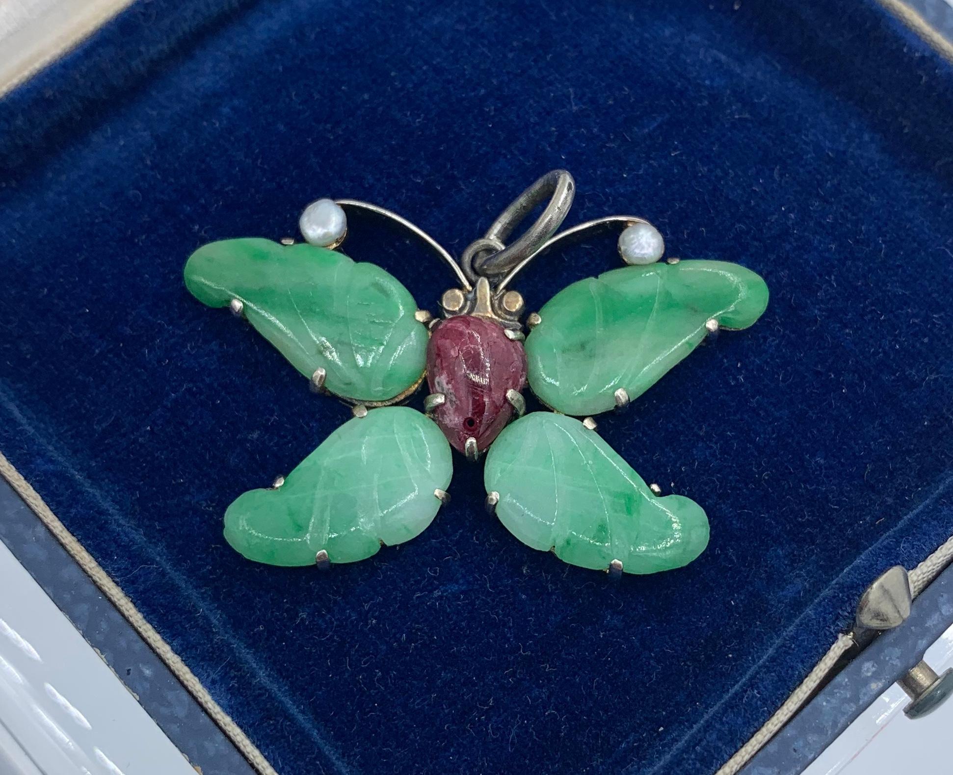 This is a stunning Jadeite Jade, Ruby and Pearl Art Nouveau - Art Deco Butterfly Insect Moth Pendant.  The wings of the butterfly are beautiful carved Jadeite Jade.  There is lovely variation within the Jade creating the colors of the wings.  The