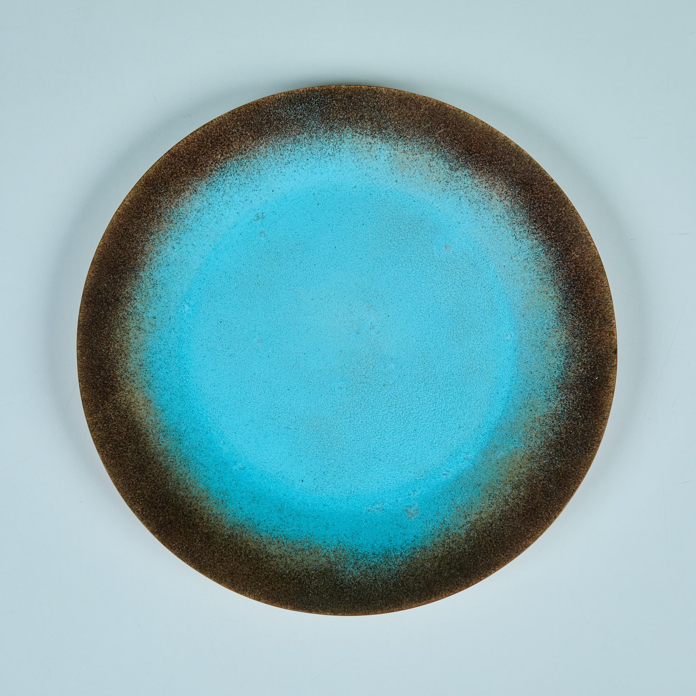 Copper enameled plate by California artist, Jade Snow Wong c.1950s. The plate features a copper form with a turquoise enamel glaze. Signed on the underside.

Dimensions
10.5