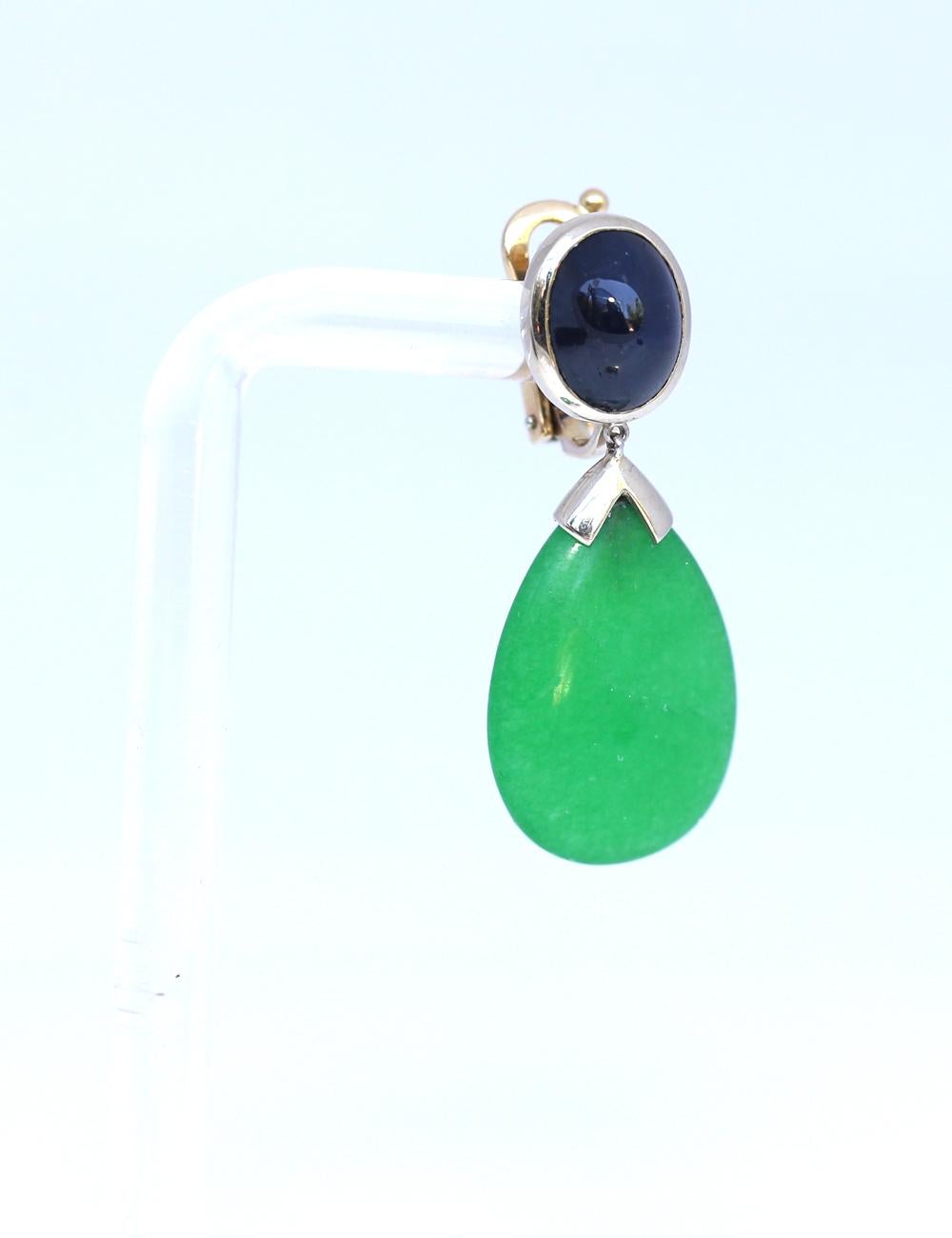 Fine Jade and Star Sapphire cabochon earrings. Modern yet classic in style it is a comprehensive jewelry item for every day. Looks wonderful on the ear and moves freely with the head. There is a black spot on the bottom of one Jade, it is