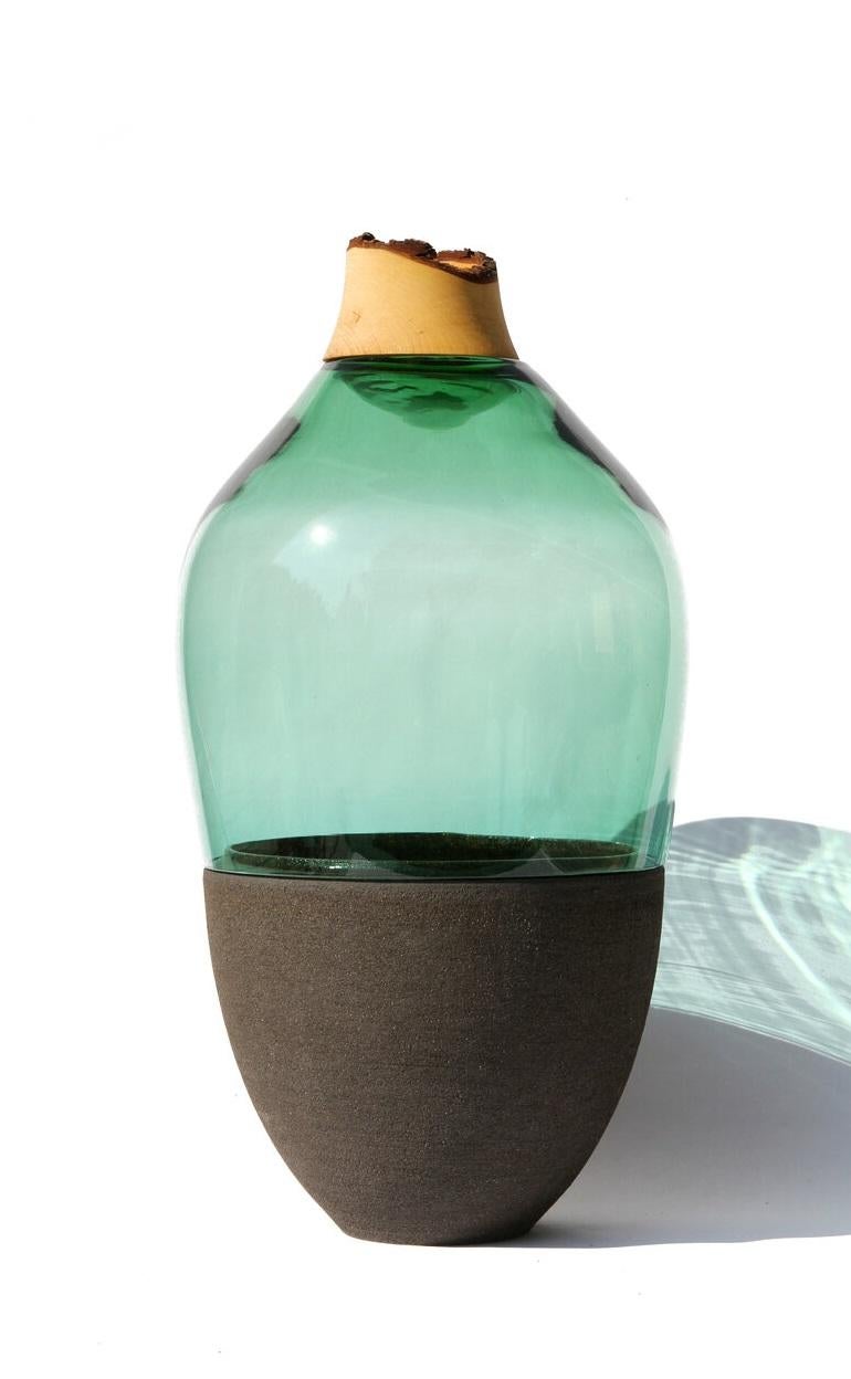 Jade TSV5 stacking vessel, Pia Wüstenberg.
Dimensions: D 26 x H 65.
Materials: glass, wood, ceramic
Available in other colors.

Handmade in Europe: handblown glass (Czech Republic), ceramic (handmade in Scotland), hand turned wood