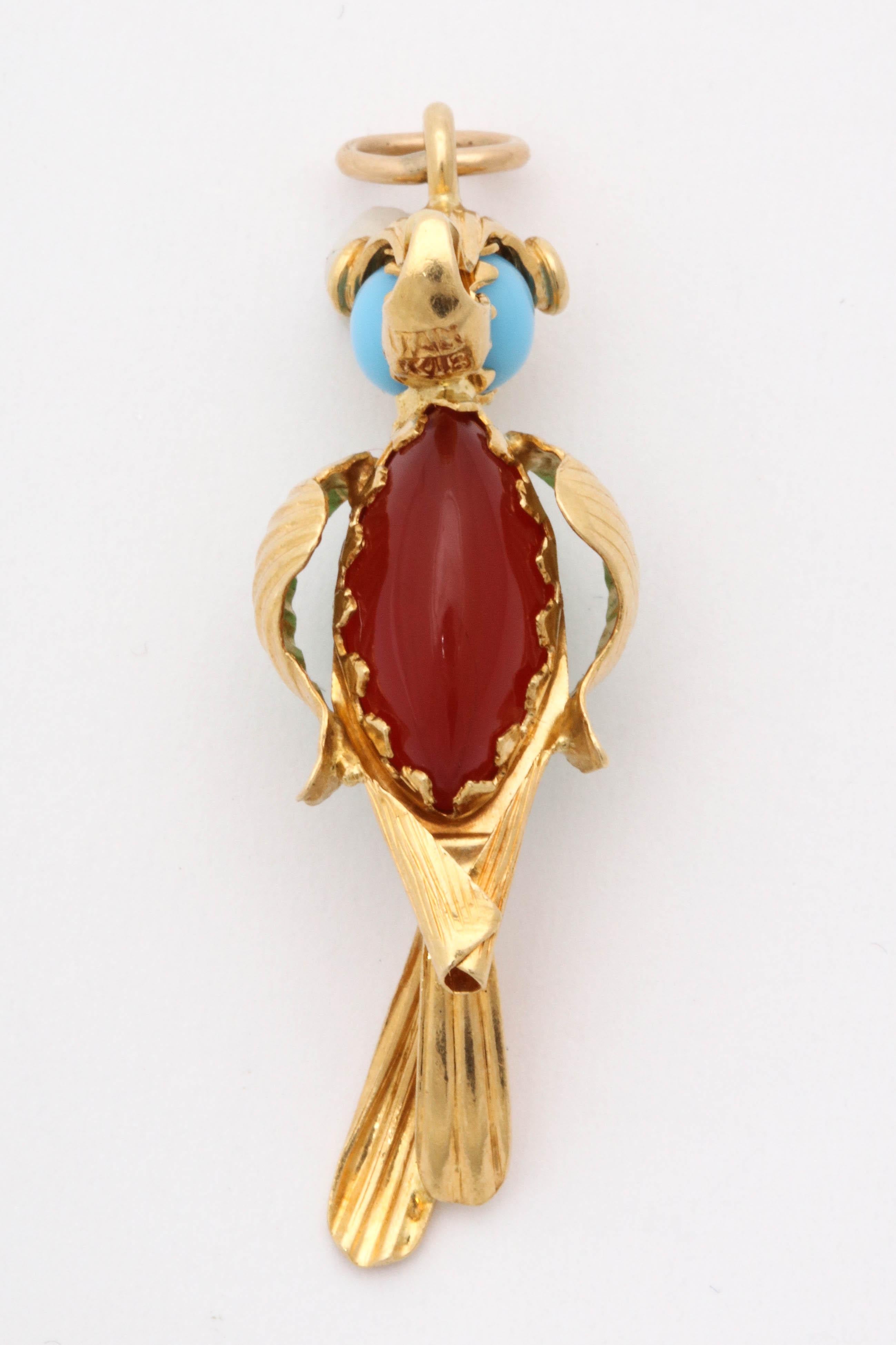 One Ladies 18kt Yellow Gold Figural And Whimisical Parrot Charm Brooch Embellished With One Marquis Cut Cabochon Jade Piece And On The Otherside Of His Body A Marquis Cut Carnelian Stone. Also Embellished With Two Turquoise Stones And Red Enamel For