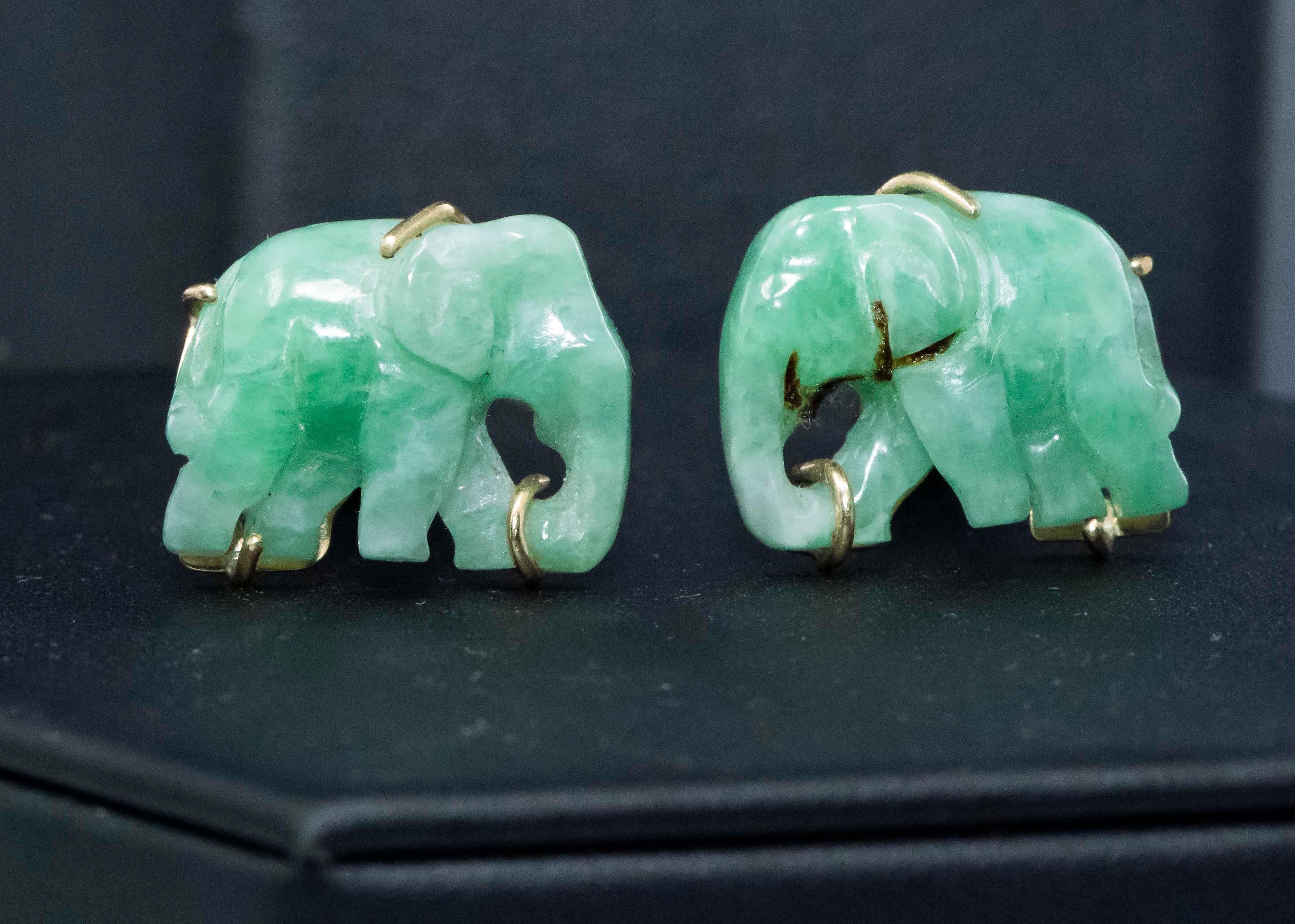 The present cufflinks are green jade elephant shaped cufflinks exhibiting good color throughout approximately 20mm wide tail to trunk by 15mm in height and are set in 14kt yellow gold mount with a depth of 32mm, circa 1960s. Additionally, they are