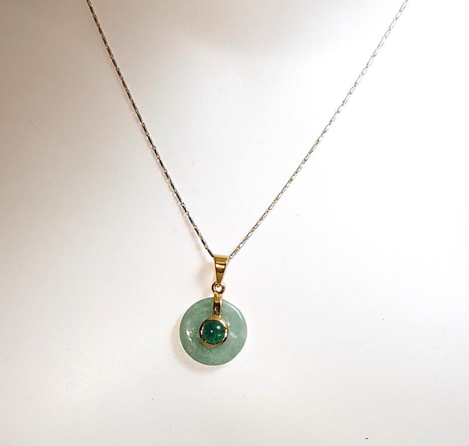 Jade with Cabochon Emerald 0.60 carat Pendant set in 14K Gold Settings
(chain not included)

Width: 1.5 cm 
Length: 2.4 cm
Total Weight: 2.17 grams

