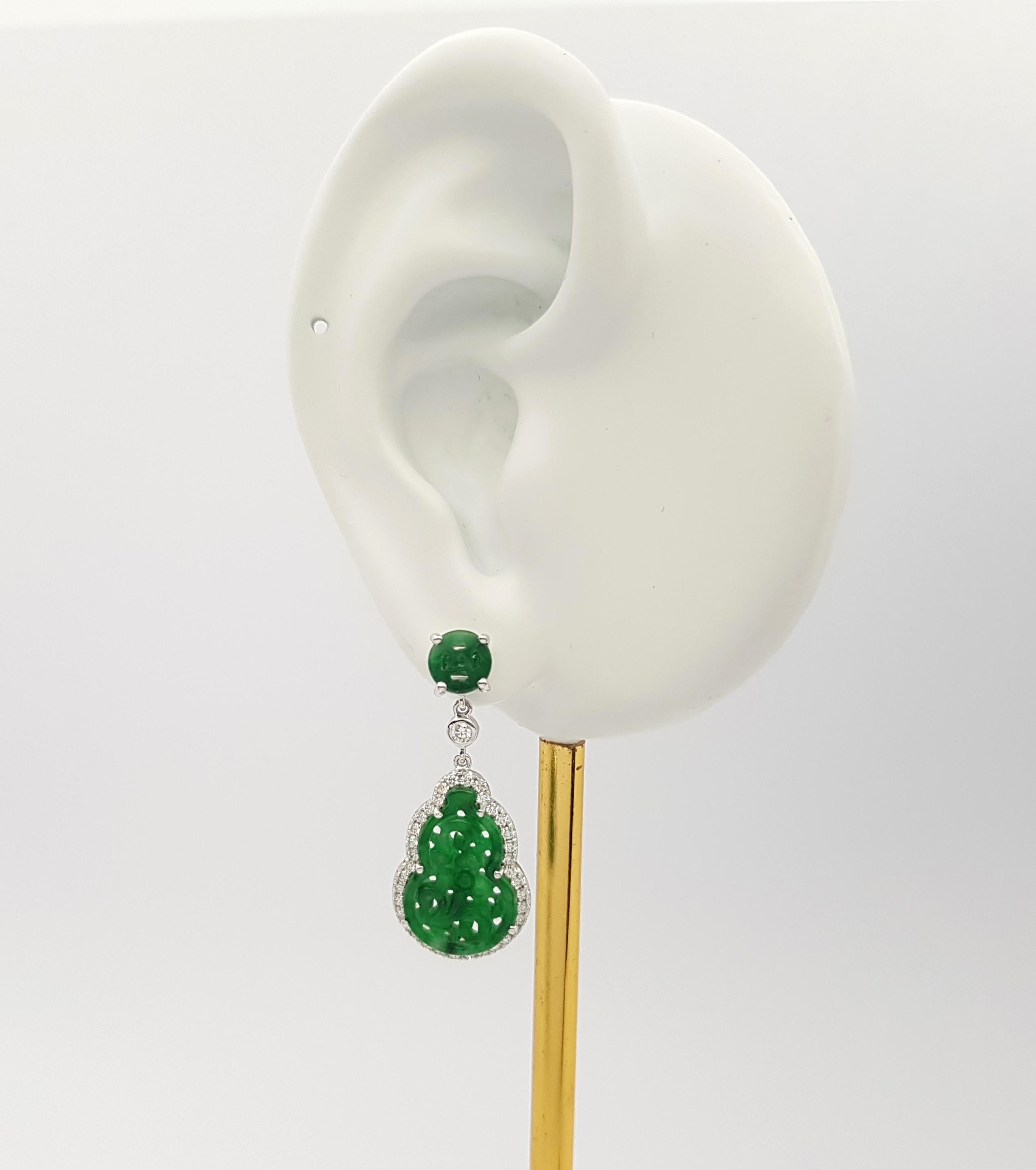 Jade 5.75 carats with Diamond 0.60 carat Earrings set in 18K White Gold Settings

Width: 1.3 cm 
Length: 3.1 cm
Total Weight: 7.69 grams

