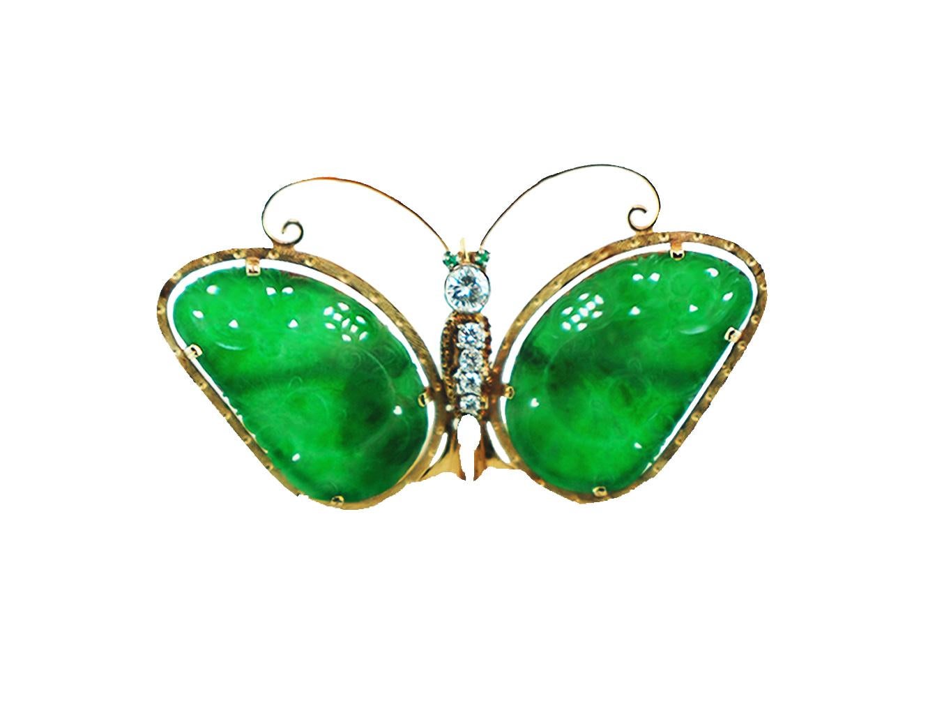Jadeite and Diamond Butterfly Pin or Brooch with beautiful quality diamonds and emerald gemstone antenna
Spectacular colored green jadeite is carved into a butterfly pendant or brooch and expands over 2.75 inches wide and 1.75 inches tall. 
The