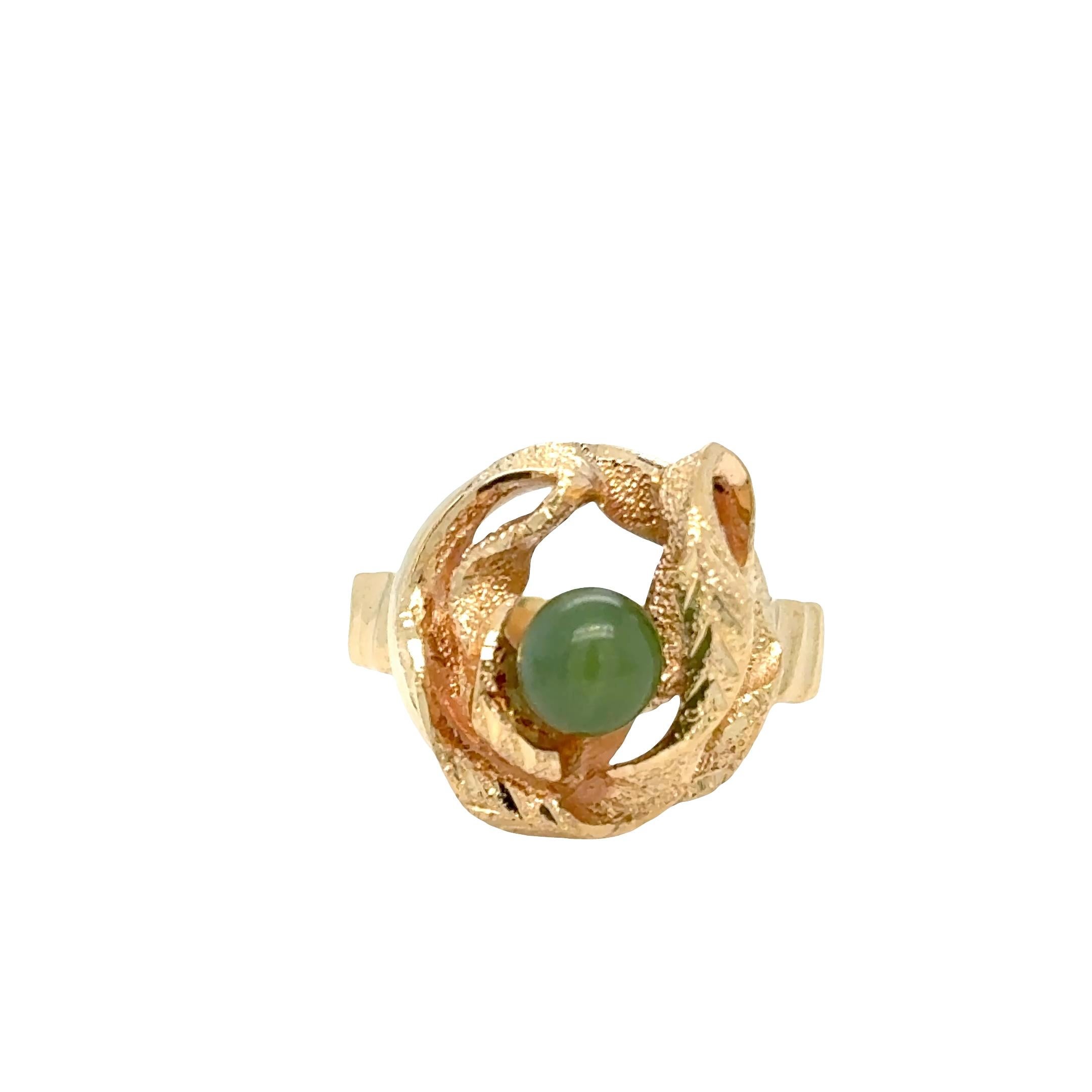 Sculptural elegance meets natural beauty.
At the heart of this unique ring is a lush green jadeite bead, gracefully wrapped in a flowing 14k yellow gold ribbon twist. The organic curves evoke a sense of movement, like silk in motion—offering a
