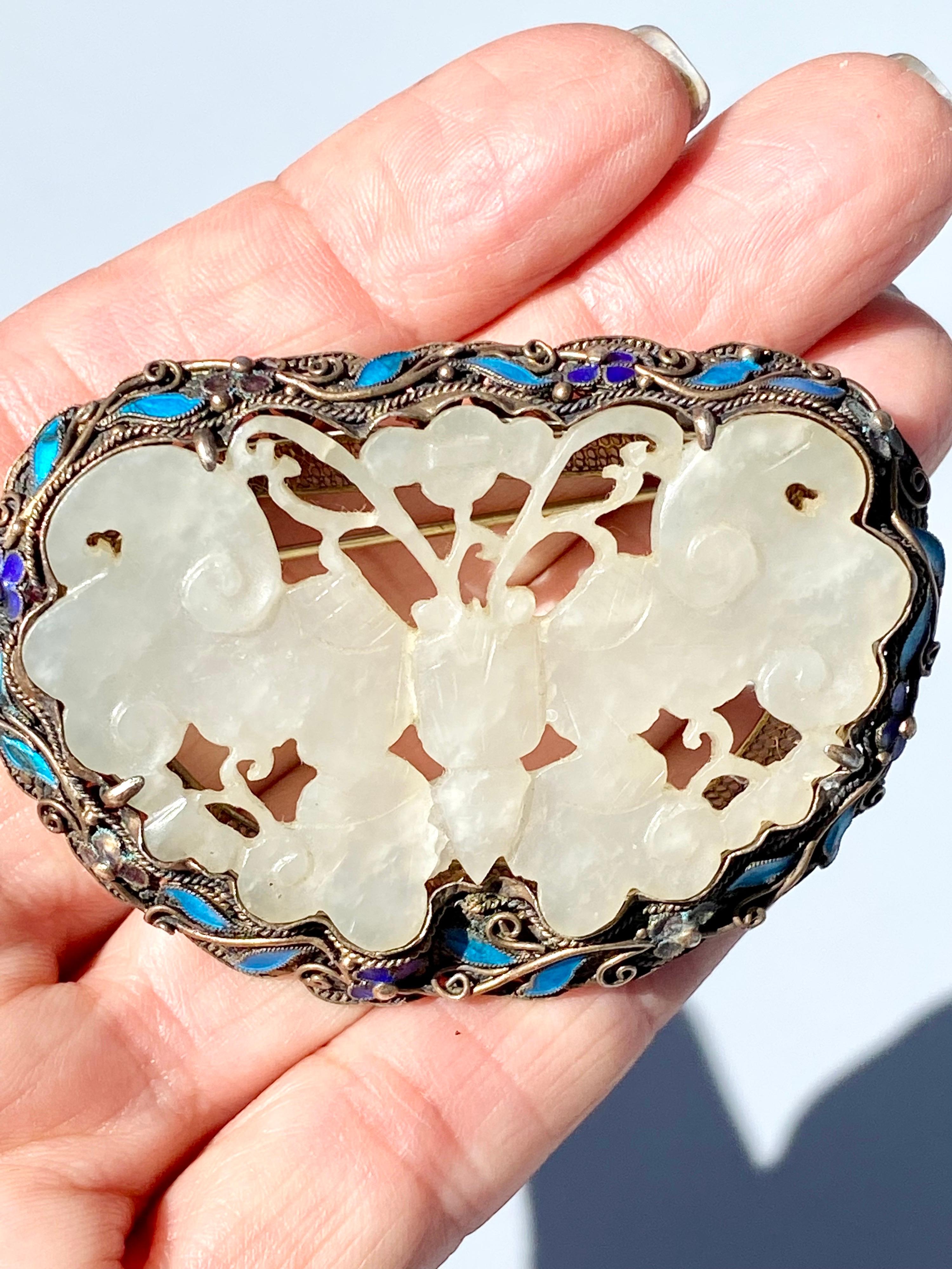 Jadeite Butterfly Enamel and Lapis Brooch Pin Circa 1970

Whimsical artistry of carvings detailed in jade set in a silver scrolled frame. Enameling is colored in turquoise and lapis lazuli surrounding the butterfly. The brooch measures 2.75 x 2