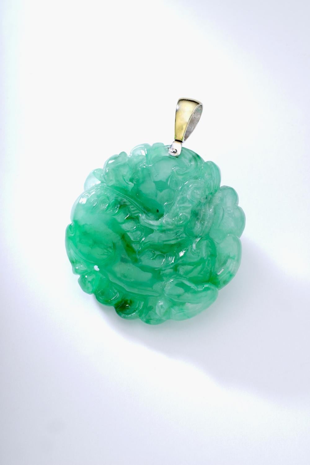 Step into the realm of elegance and grace with our Jadeite Overall Carved Oversized Pendant. This stunning piece of jewelry showcases the timeless beauty of jadeite, carefully carved to perfection with intricate detailing on both sides, making it a