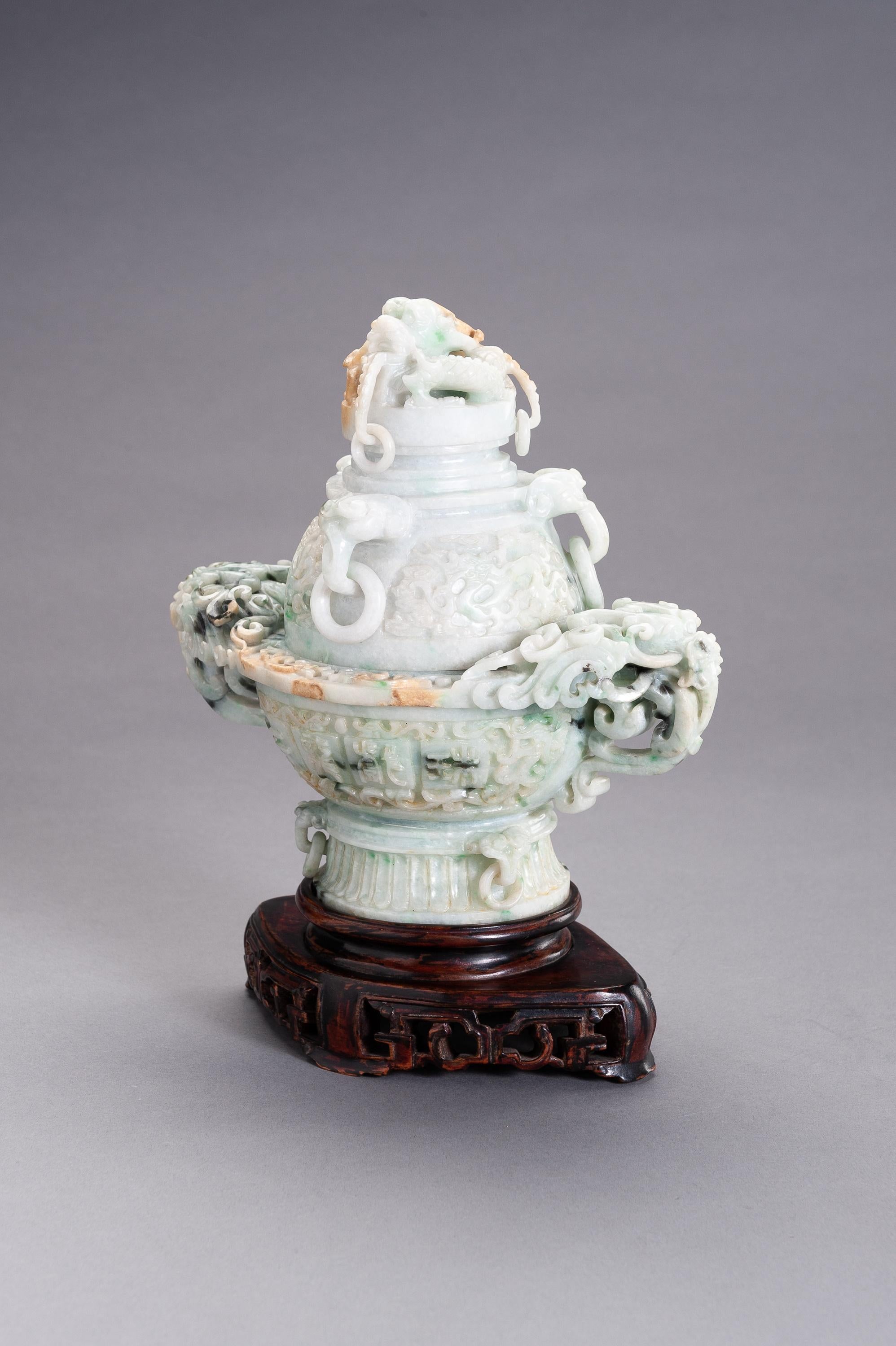 Jadeite censer and cover with dragons, China, 20th century

The censer and cover show impressive relief carving, the thick walls with a dragon motif on one side and a four-character inscription on the other reading ‘Er Long Xi Zhu’ (Two dragons
