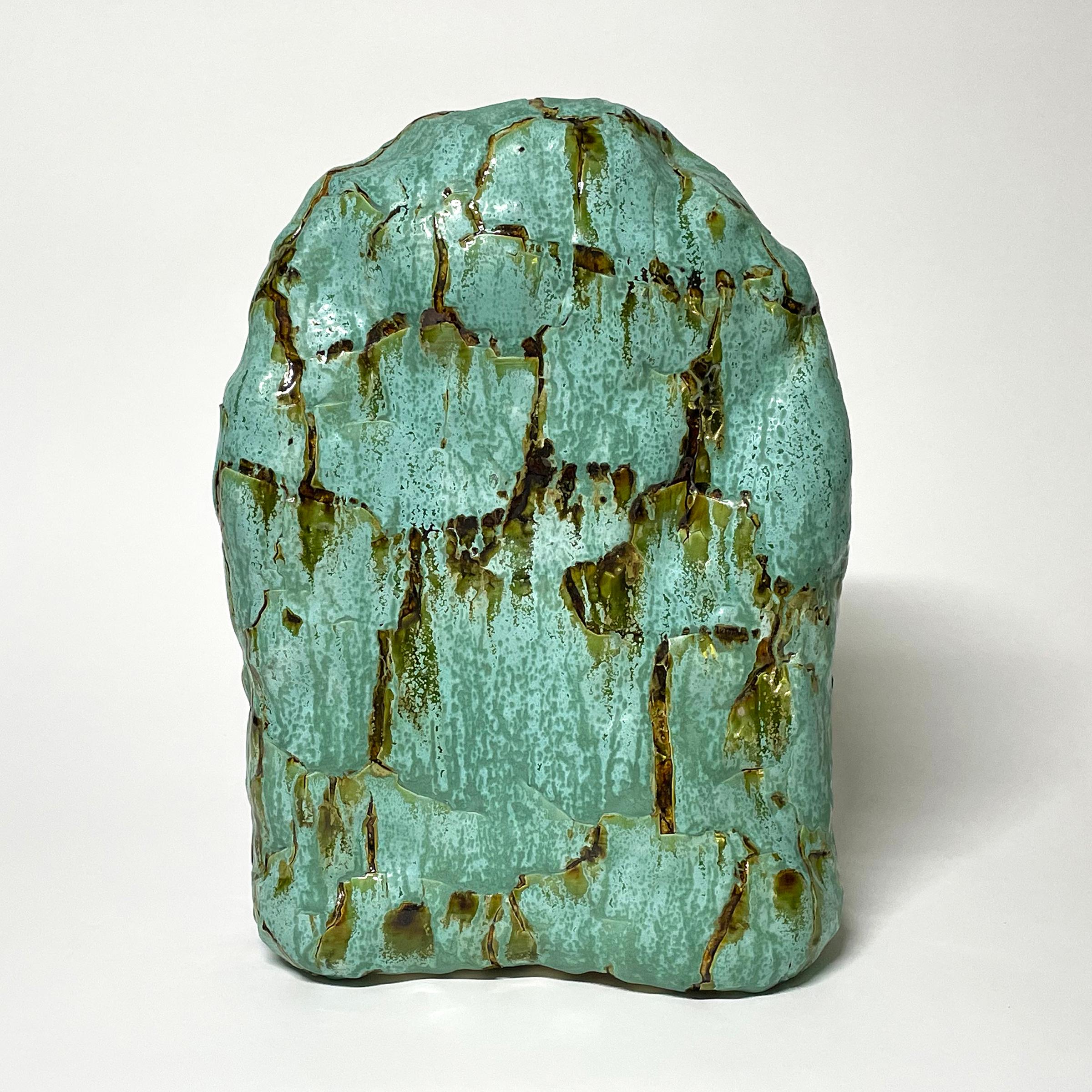 Glazed ceramic sculpture by William Edwards  2016
Hand built earthenware sculpture, fired multiple times to achieve a textured surface of random abstraction, in hues of green with amber gloss glaze breaking through.

William received his BFA in