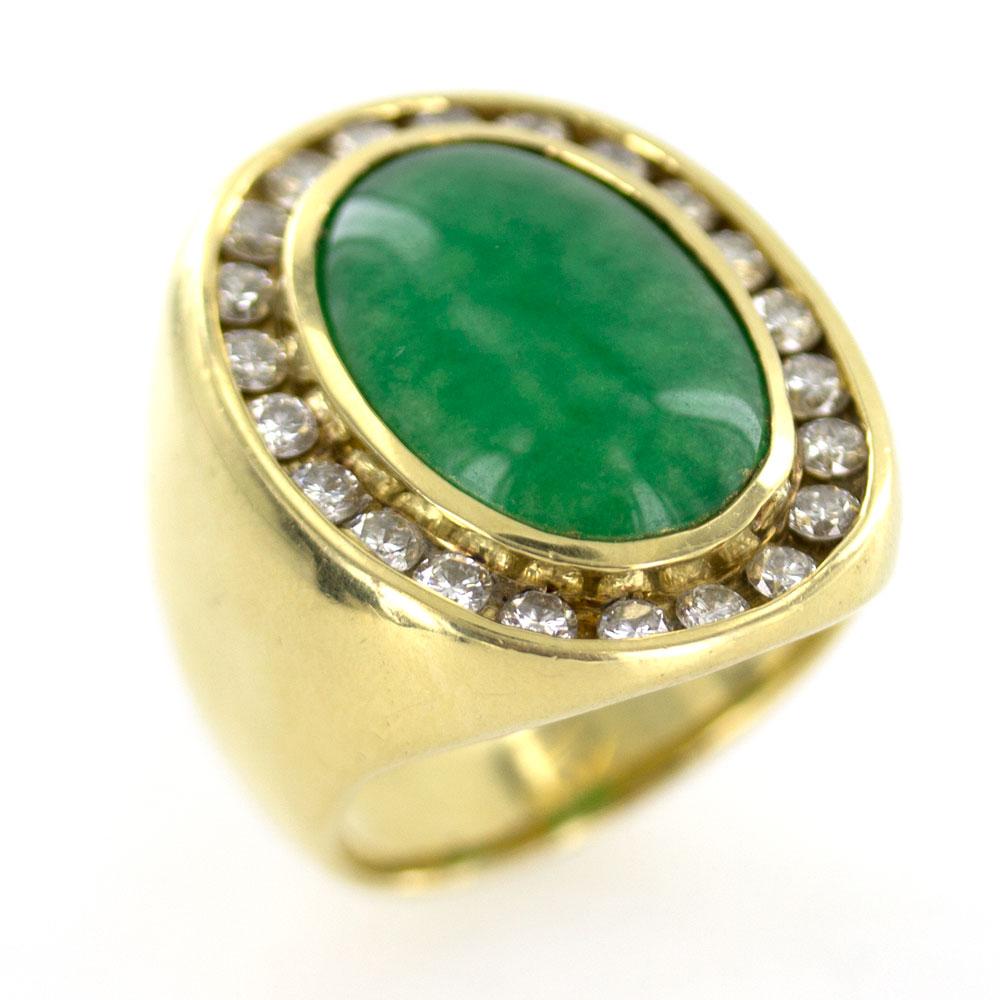 Large Jadeite diamond unisex ring. Circa 1970's, this ring is crafted in 18 karat yellow gold. The ring features an oval jadeite gemstone surrounded by 22 round brilliant cut diamonds that equal approximately 2.20 carat total weight. The top