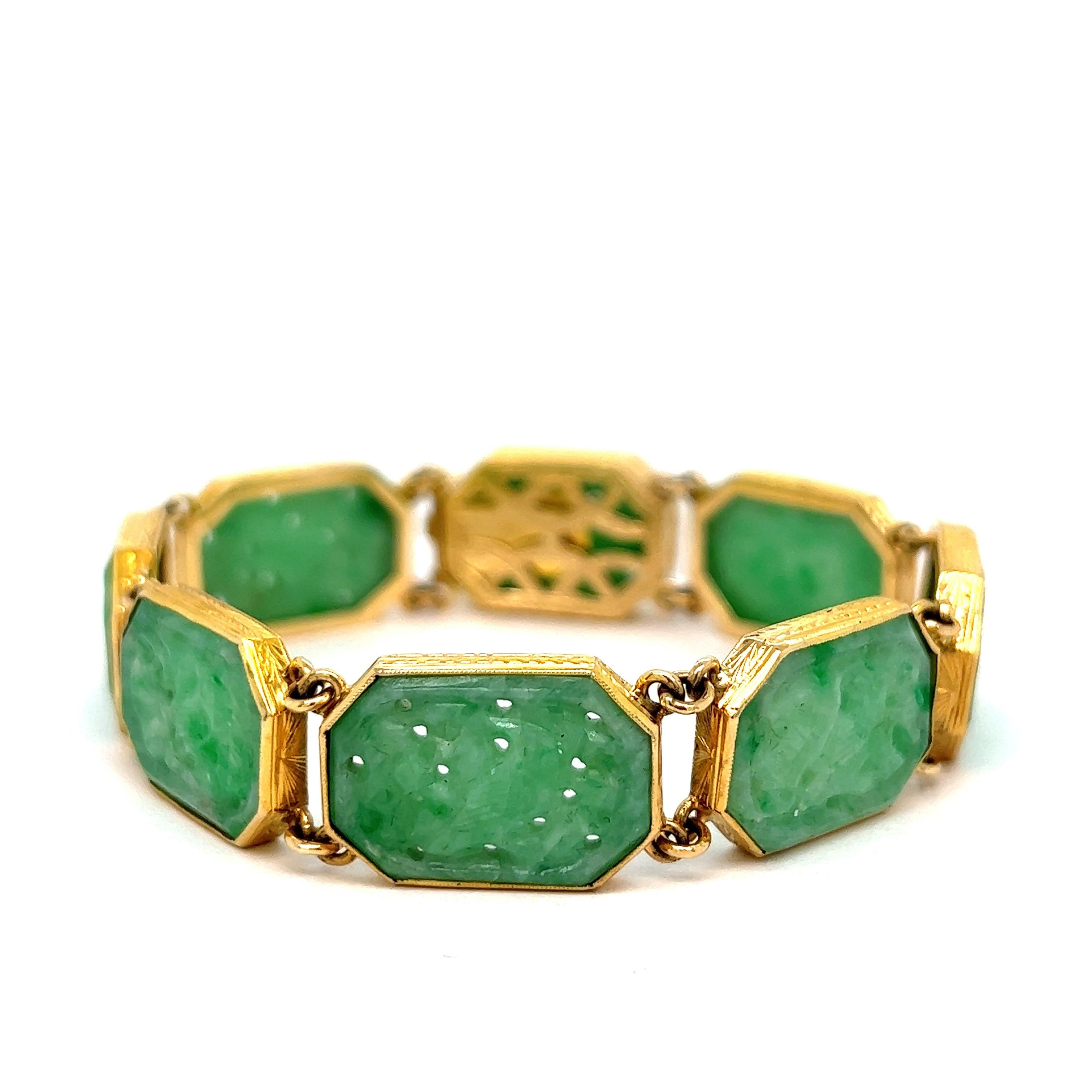 Jadeite gold link bracelet

Elongated octagonal links of hand carved jadeite center stones, featuring an openwork bird motif; wheat style accents adorn the bezels of each link; marked 14k

Size: width 0.5 inch, length 7.25 inches
Total weight: 27.8