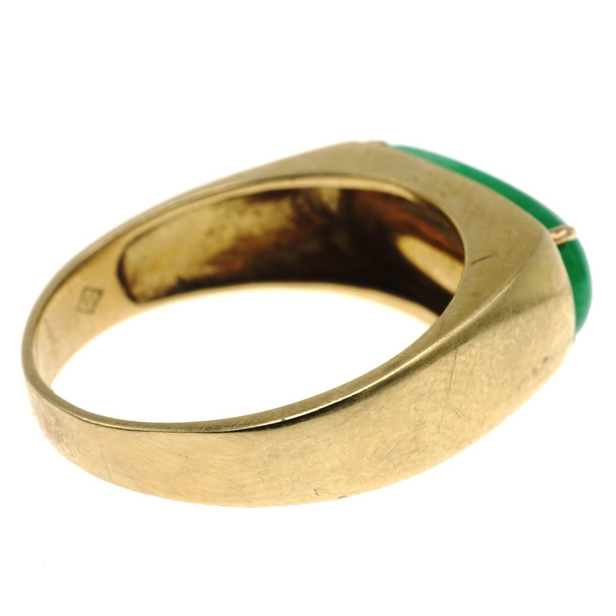 Crafted in 18 karat yellow gold this ring features a stunning piece of jadeite jade measuring 17.17 x 6.48 mm.  Ring size 10 weighs 6.5 gr./4.2 dwt.  Signed and stamped with marker's mark
