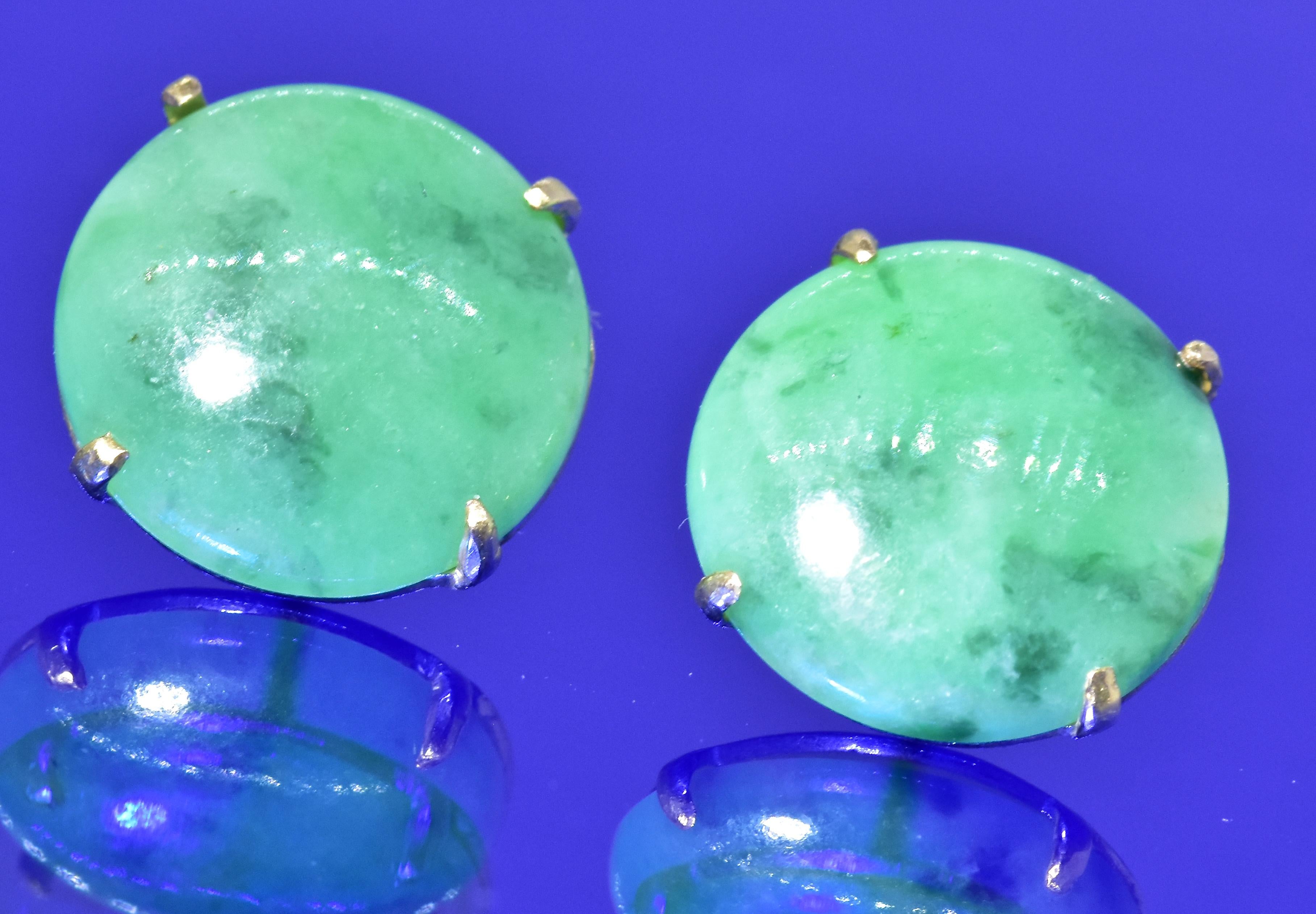 Jadeite jade set in simple gold settings, these stud type earrings are .50 inches in diameter.  The natural jadeite jade is a pretty medium color green with some darker green.  The two jade disks are well matching and prong set in yellow gold.  In