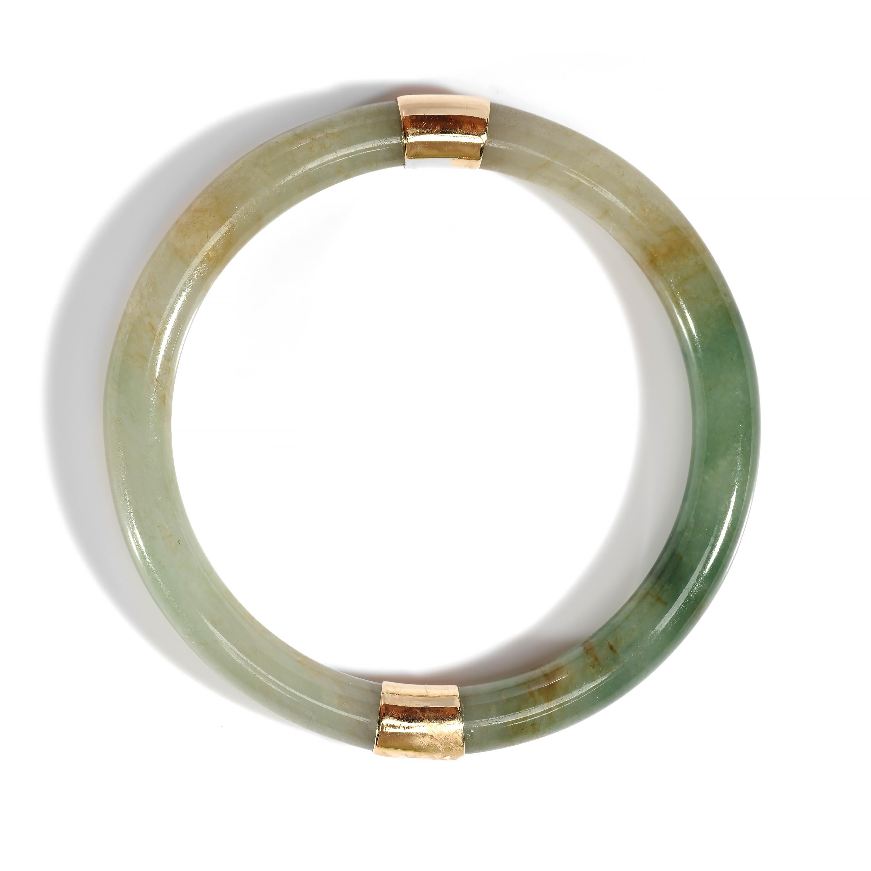 A glassy, highly translucent jadeite jade bangle in an autumnal palette of mossy green, pale sage, ruddy earth, and a light bluish-gray. This delicate, luminous bangle was hand-carved and hand-polished and is composed of two half-round segments