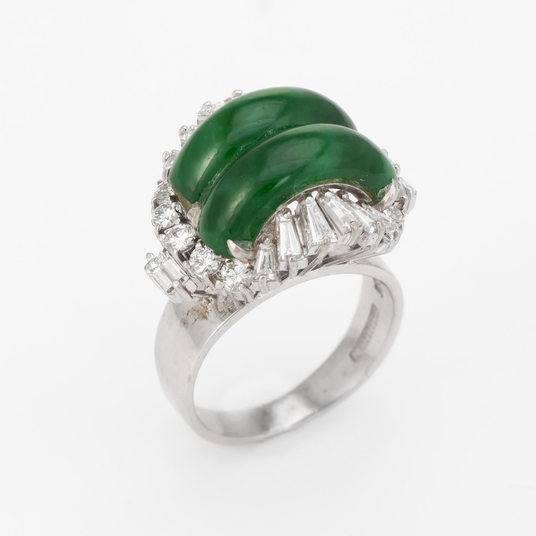 Elegant vintage jadeite & diamond cocktail ring (circa 1950s to 1960s), crafted in 14 karat white gold. 

Cabochon cut jade measures 14mm x 5mm (each), accented with an estimated 0.78 carats of mixed cut diamonds (Round brilliant, straight and