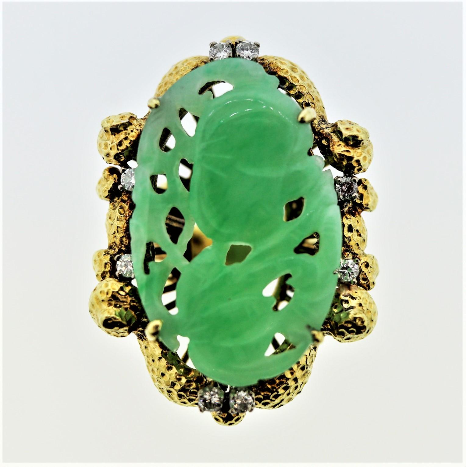 A large and highly detailed jadeite jade ring that doubles as a work of art! It is stunning in its design and natural motifs which include the jade. The jade is hand carved to depict natural foliage blowing in the wind. It is complemented by 8 round