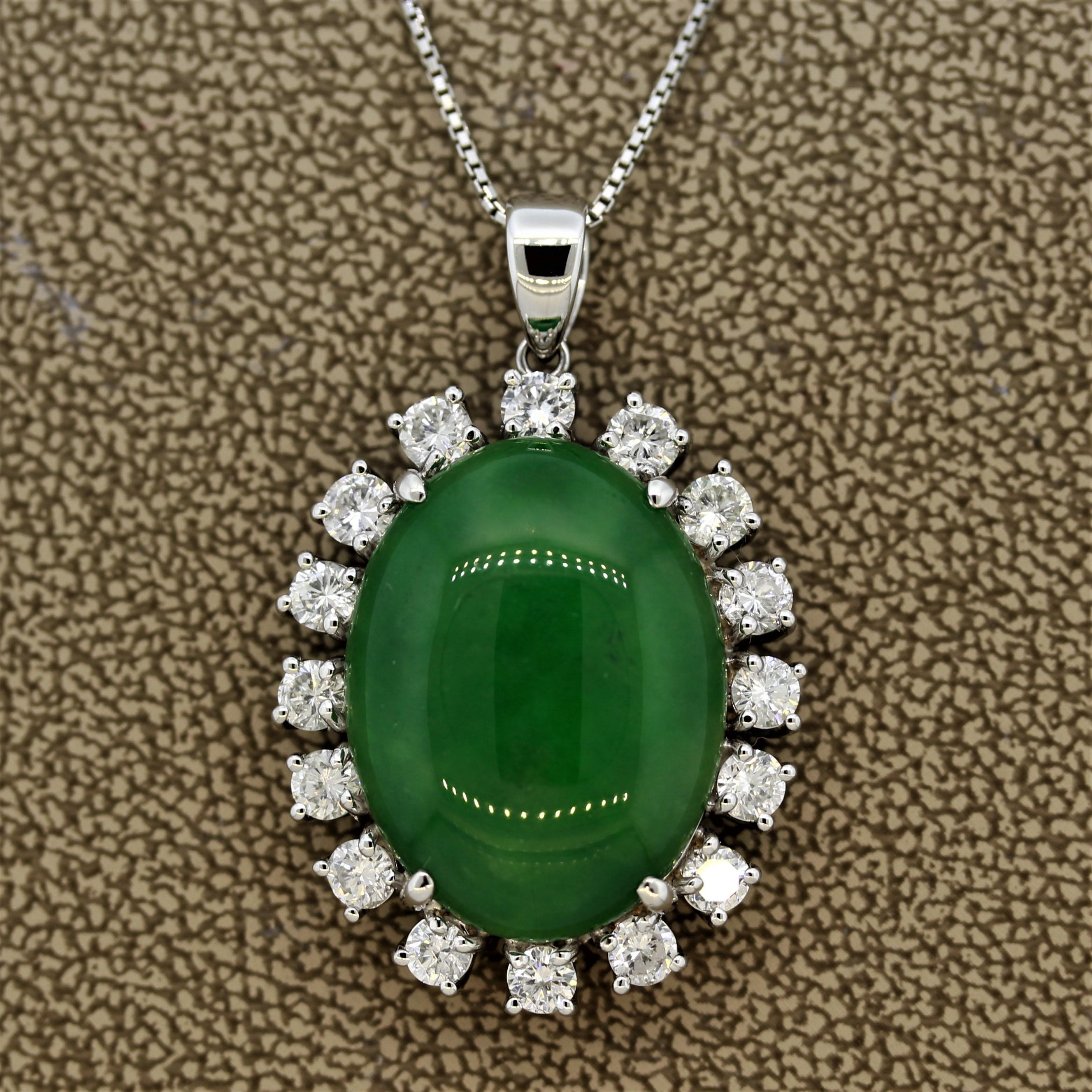 A large and luscious piece of natural jade weighing 15.26 carats takes center stage in this platinum piece. The jade is haloed by 1.88 carats of larger round brilliant cut diamonds each in a platinum 4-prong setting.

Pendant Length: 1.25