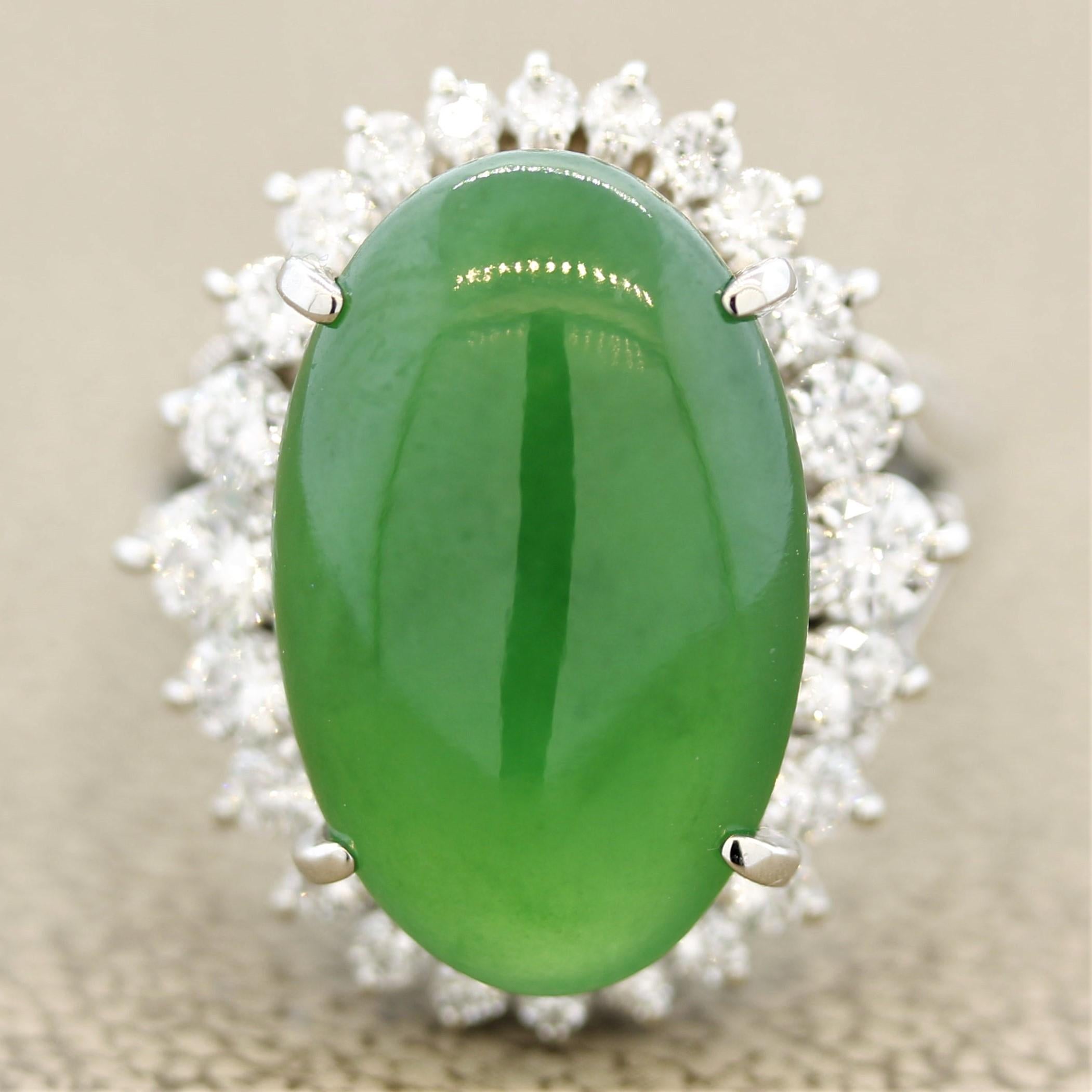 Wow, simply stunning. This ring features a 10.06 carat natural jadeite jade with no treatment. It has a rich evenly colored grass green color that is sought after by collectors. It is accented by a graduating halo of 0.94 carats of round brilliant