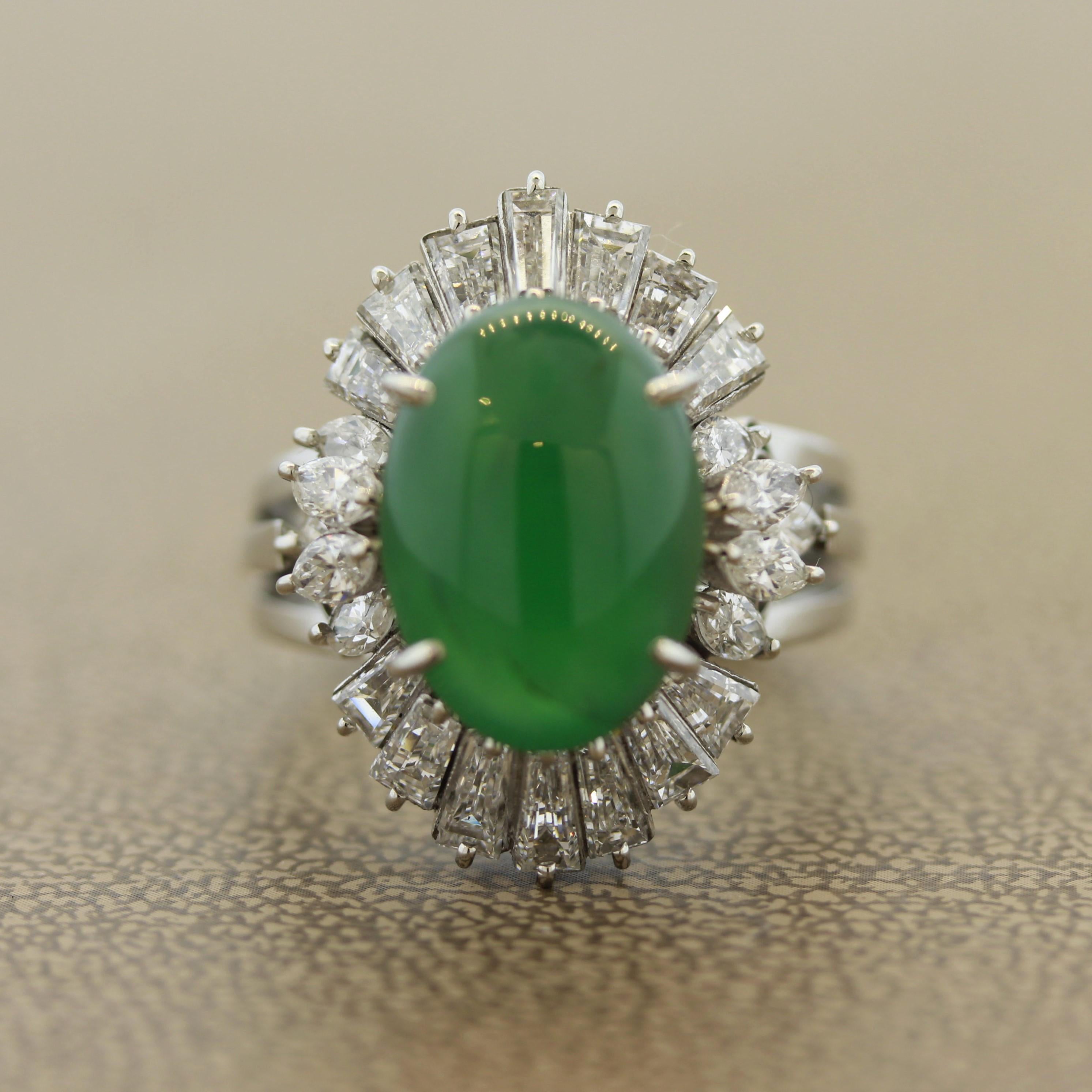 A spectacular piece of natural jadeite jade takes center stage of this cocktail ring. It has a bright apple green color and a glossy luster that rolls light softly across its face. It is complemented by pear shape and tapered baguette cut diamonds