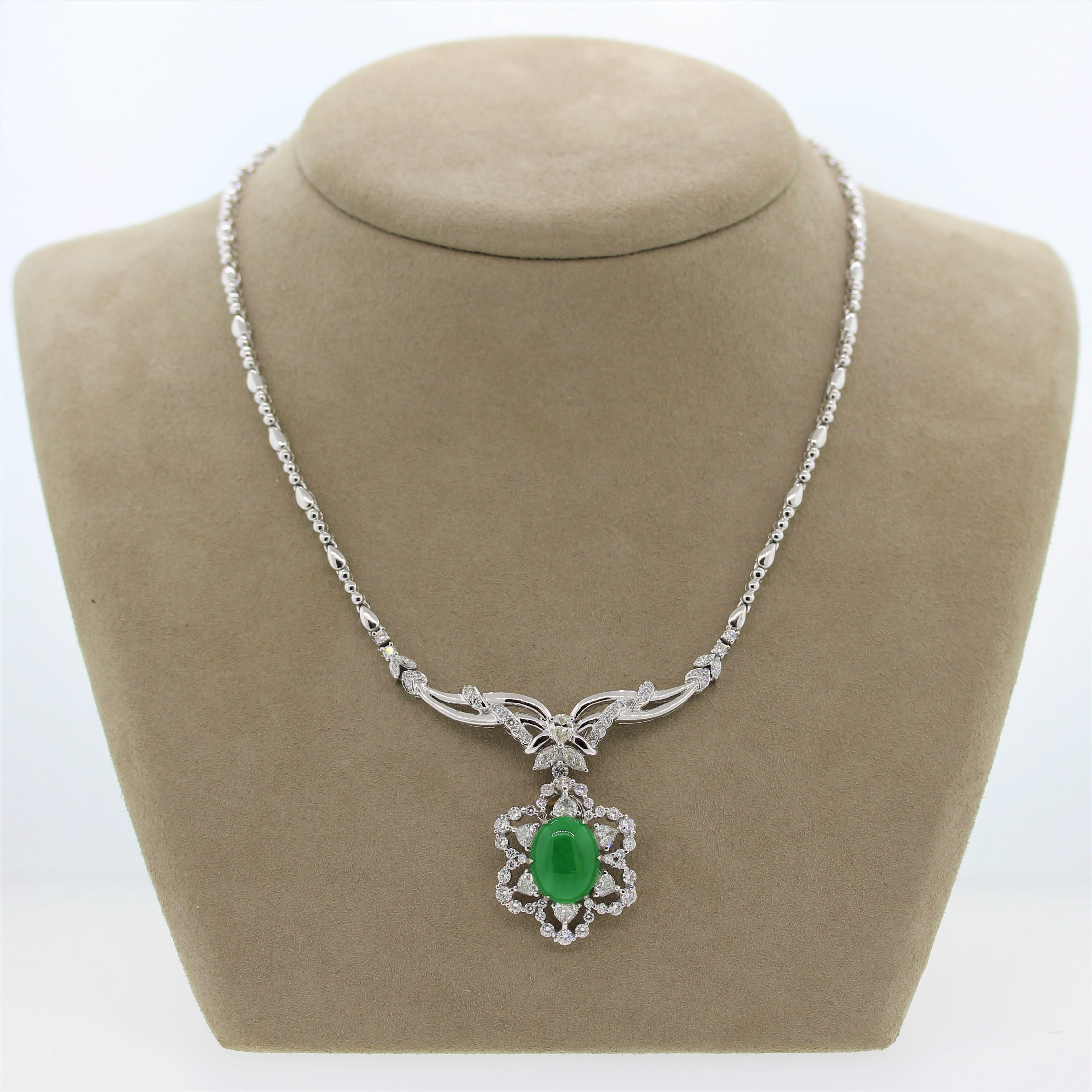 An indulgent necklace featuring a 5.28 carat natural jadeite jade. The oval shaped gemstone is accented by 4.26 carats of heart, round and marquise cut diamonds and a single pear cut. The platinum setting has a prominent filigree design that