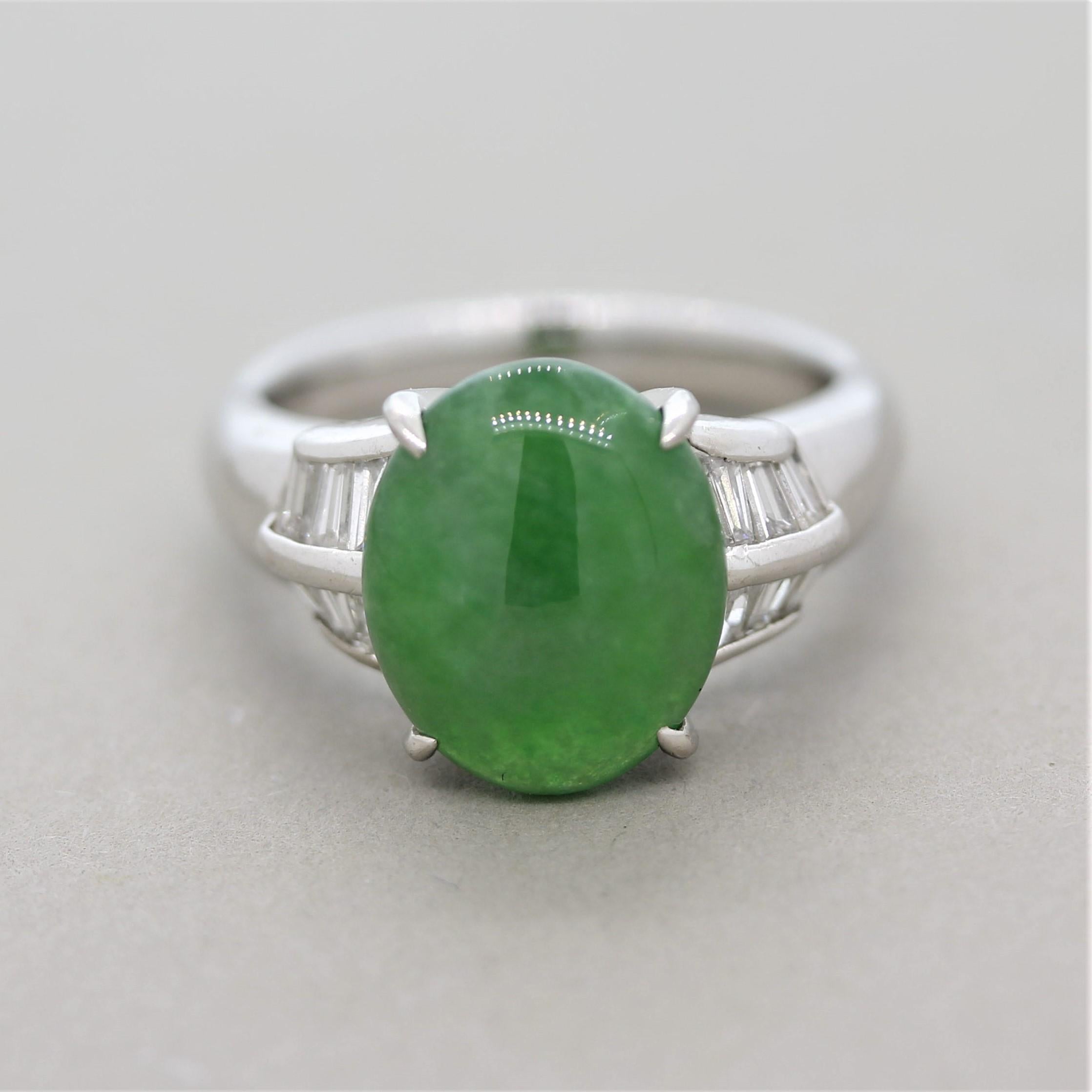 A sweet piece of jade weighing 4.64 carats takes center stage of this platinum ring. It has a rich green color and a smooth polish allowing light to evenly roll off its surface. It is accented by 0.47 carats of baguette cut diamonds set on the