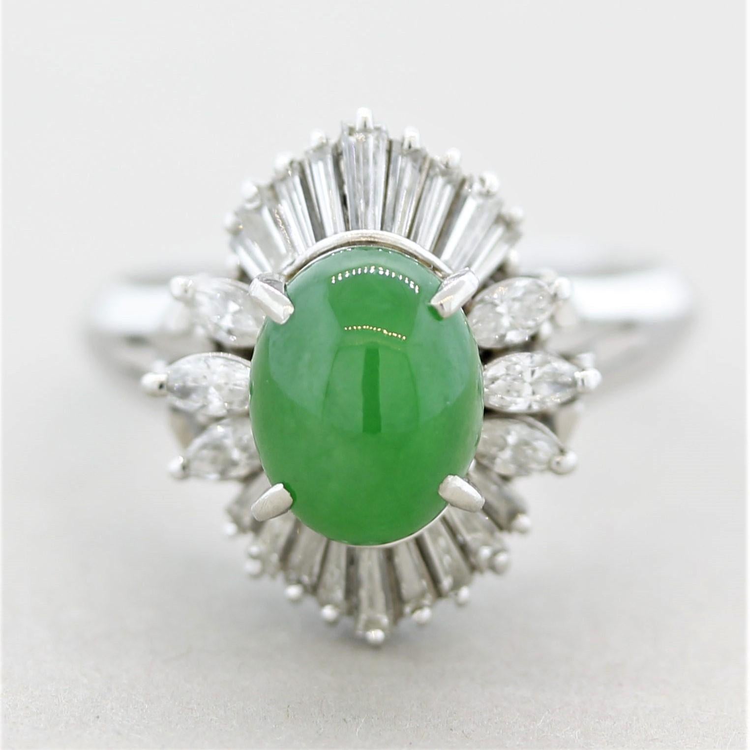 A sweet and stylish ring featuring a natural oval-shaped cabochon jade! It has an evenly colored bright-green color with excellent luster. The stone weighs approximately 2 carats and is accented by 0.87 carats of marquise-shape and baguette-cut
