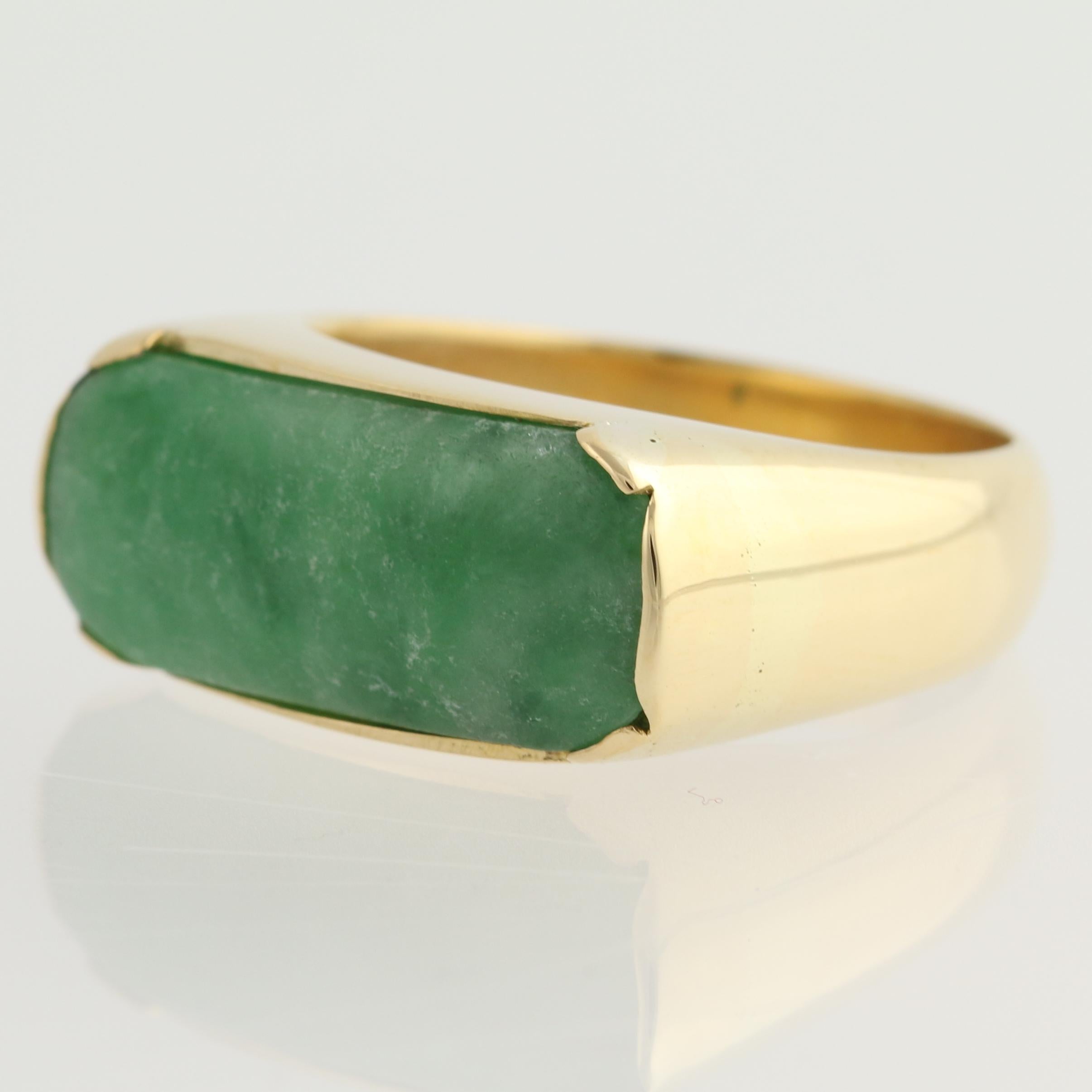 Give your ring collection an artsy look when you add this great looking men's ring! Mounted horizontally across the face of the ring in a bezel of gleaming gold, the jadeite is spring-green with swirls of a darker emerald-green. Please note that the