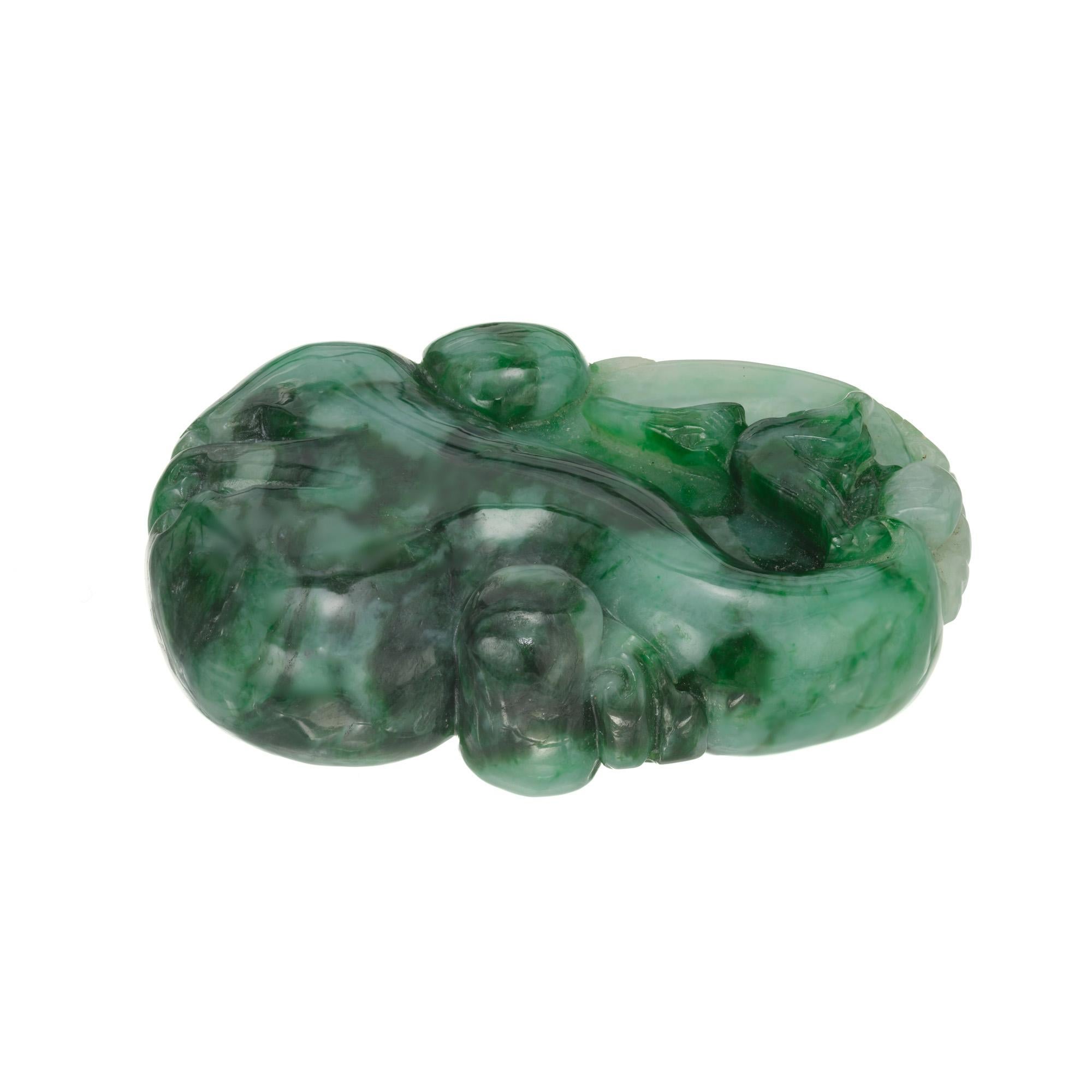Jadeite Jade carved palm stone. Dark to white green. GIA certified natural. 

1 carved jade approx. 163.97cts. GIA Certified# 6224307578
Top to bottom: 43.5xmm or 1.7 inches
Width: 31.4mm or 1.25inches
Depth or thickness: 12.9mm
Weight: 32.8 grams

 