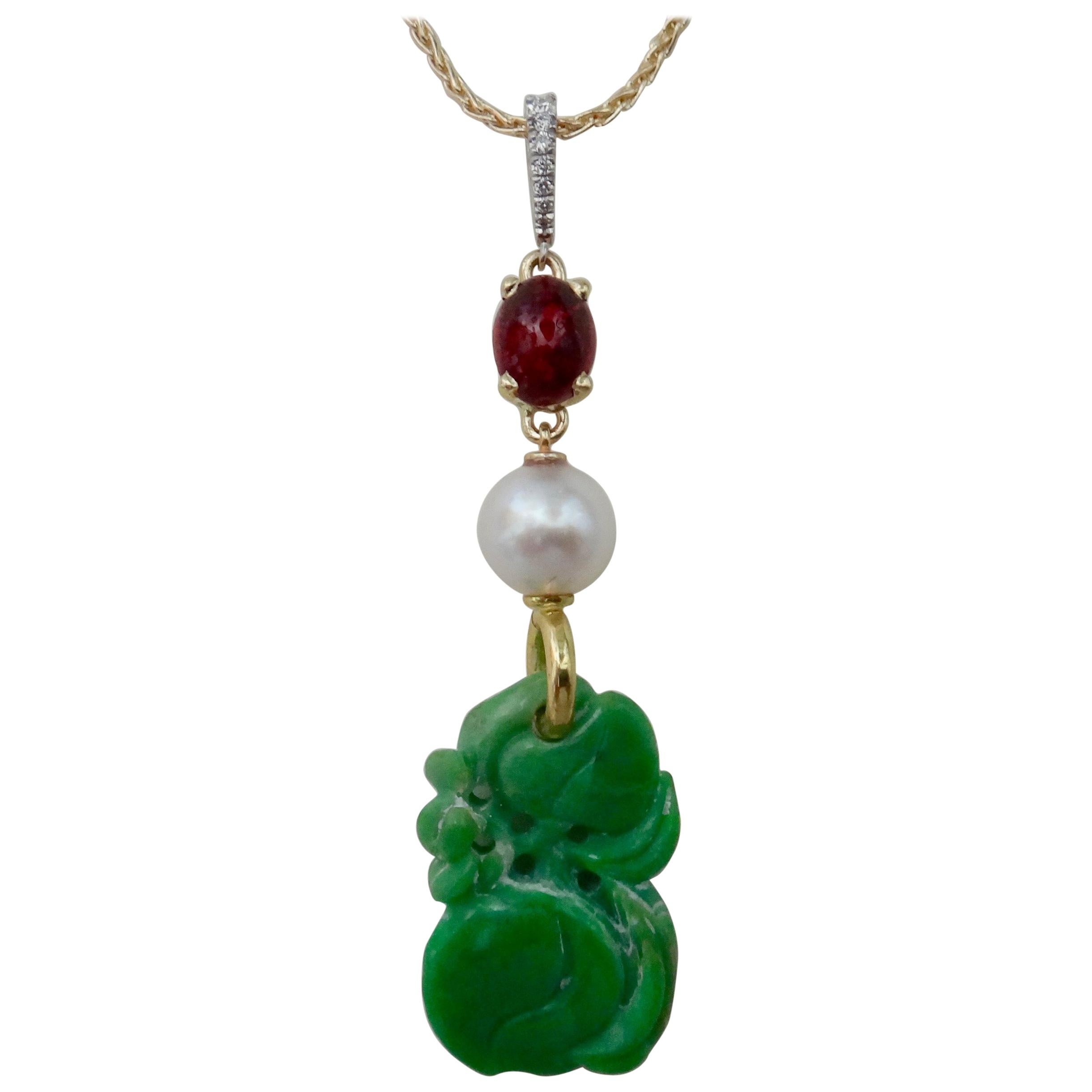 An antique carved jadeite (material origin: Myanmar, formerly known as Burma) is featured in this vintage style pendant.  The jadeite is a beautiful emerald green and it is expertly carved (probably China) in the form of two peaches with vines and