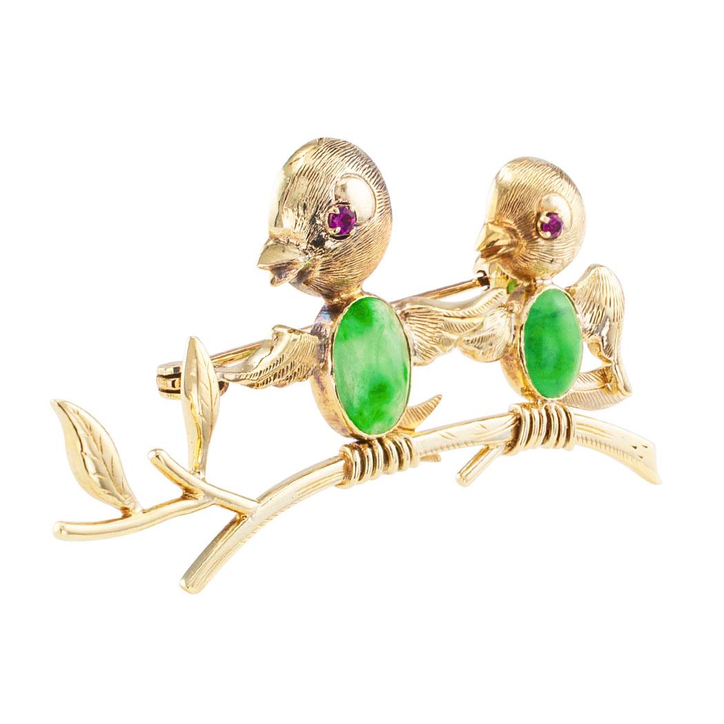 Jadeite ruby and gold bird brooch circa 1950. The design comprises two small birds perched on a single branch, the birds themselves have ruby-set eyes and jadeite breasts, crafted in 14-karat yellow gold. Very pristine condition consistent with age