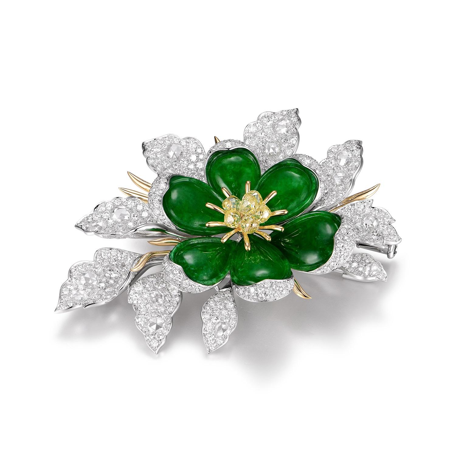 
This brooch is a luxurious amalgamation of nature-inspired elements and opulent materials. Crafted in 18-karat white and yellow gold, it features six pieces of jade, combining to a total weight of 7.0 carats, arranged in a symmetrical floral