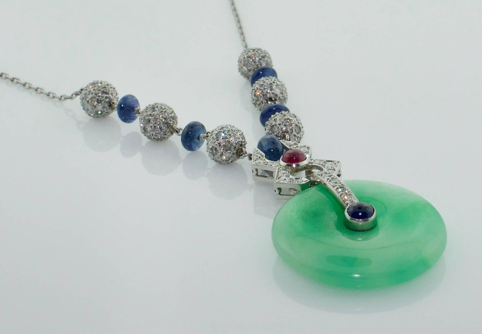 Jadeite, Diamond, Ruby and Sapphire  Necklace
A beautiful Jadeite Disk is The Focal Point of This Spectacular Necklace
With Sapphire Ron-dells and a Cabochon  Ruby and Sapphire 
3.55 carats of Old European Cut  Diamonds color GH clarity VS-SI1 

