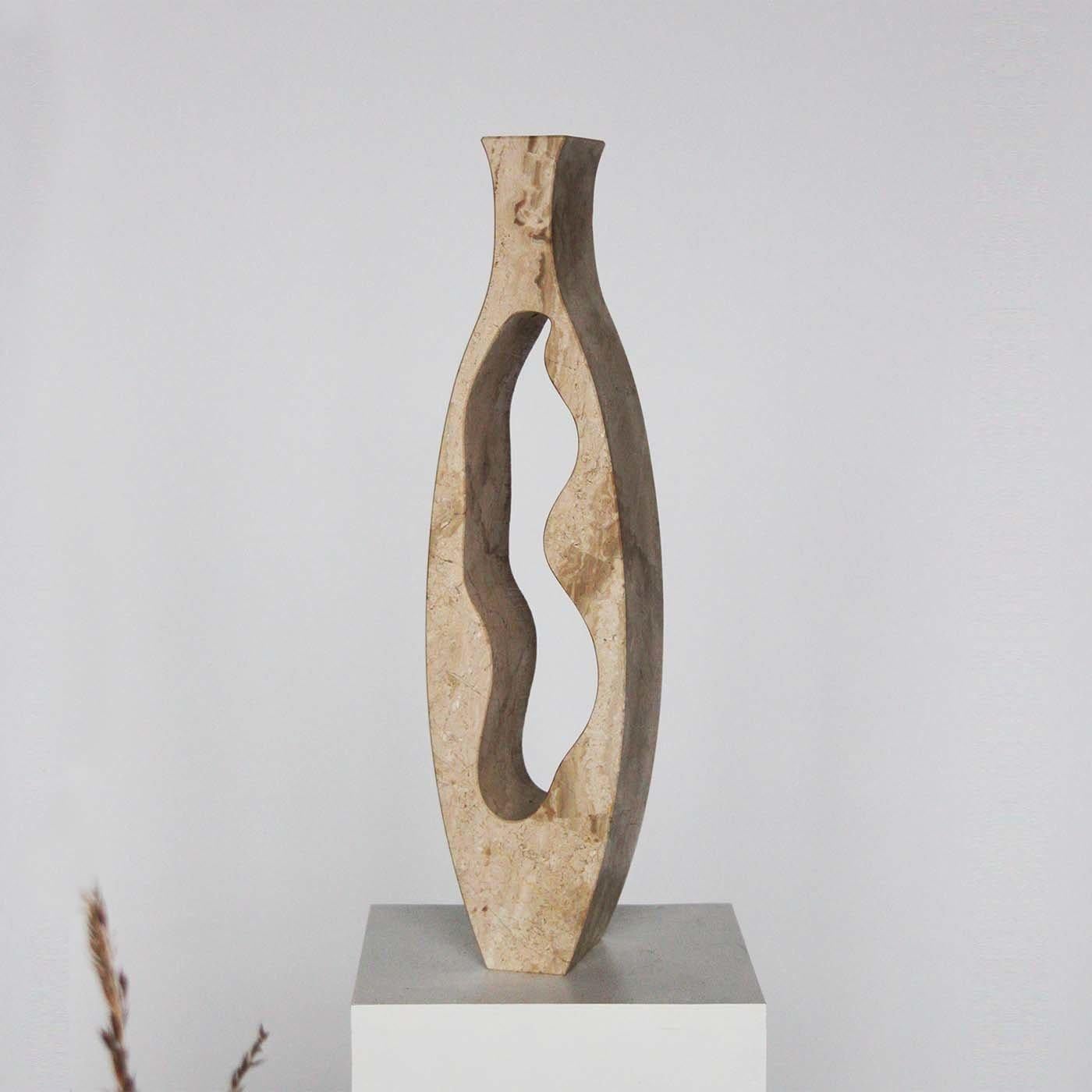 The Jae Vase is a piece entirely made in Verona, Italy, using Breccia Sarda, a unique marble from Orosei caves of east Sardinia. This vase has a slender and sinuous shape and perfectly matches the elegance of the beige and hazel-cream color of the