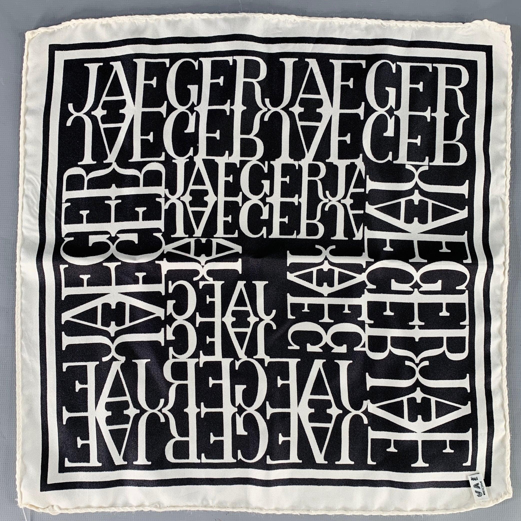 JAEGER
pocket square in a black and white silk featuring monogram logo pattern, luxurious hand rolled edges, and picture frame border. Made in Italy.Very Good Pre-Owned Condition. Minor snags. 

Measurements: 
  13 inches  x 12. inches 
  
  
 
Sui
