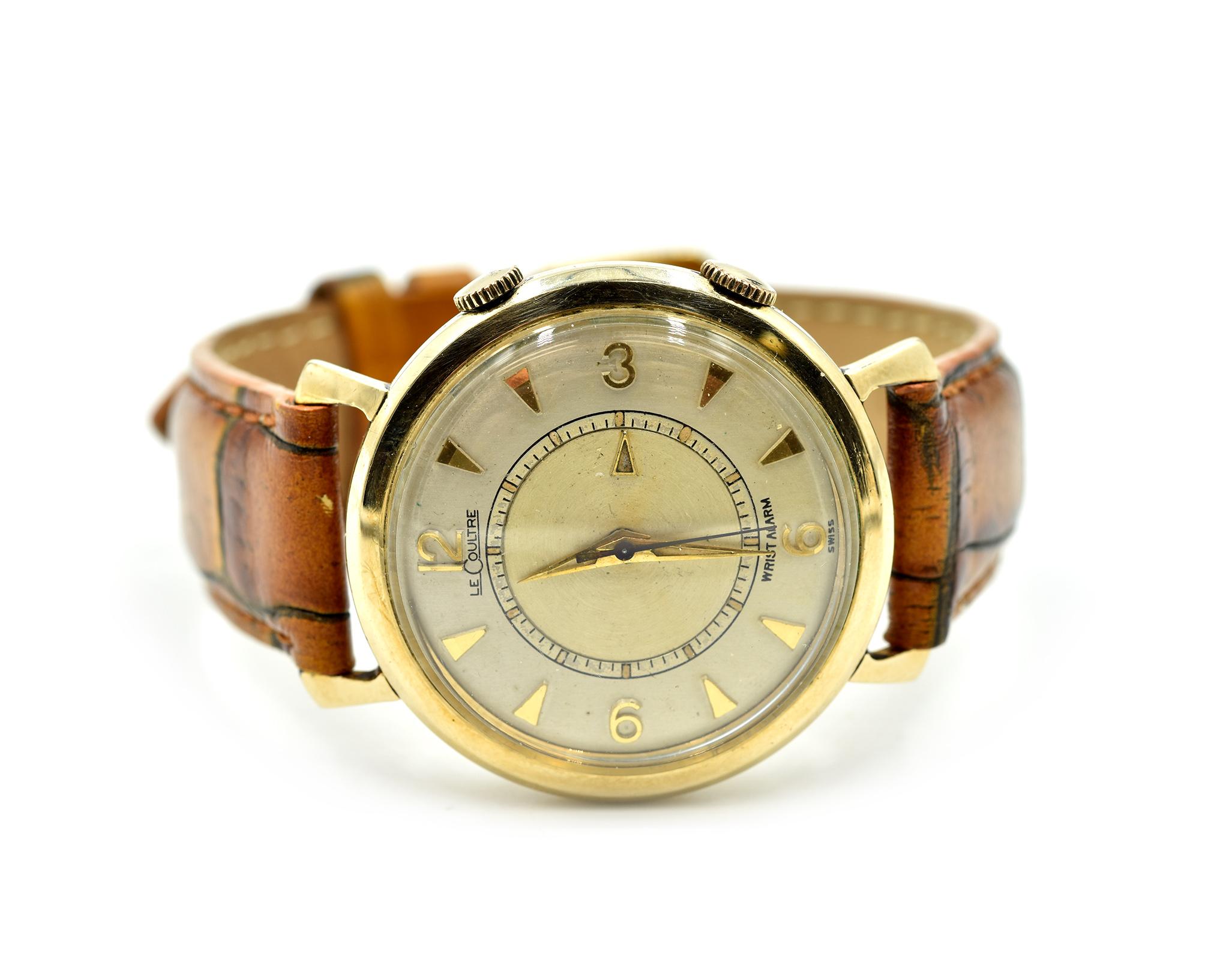 Movement: manual wind
Function: seconds, hours, minutes, alarm
Case: 34mm 10k yellow case with plastic crystal, gold bezel, pull/push crown
Band: genuine leather band with gold buckle
Dial: silver dial with gold spear and arabic hour markers
Serial: