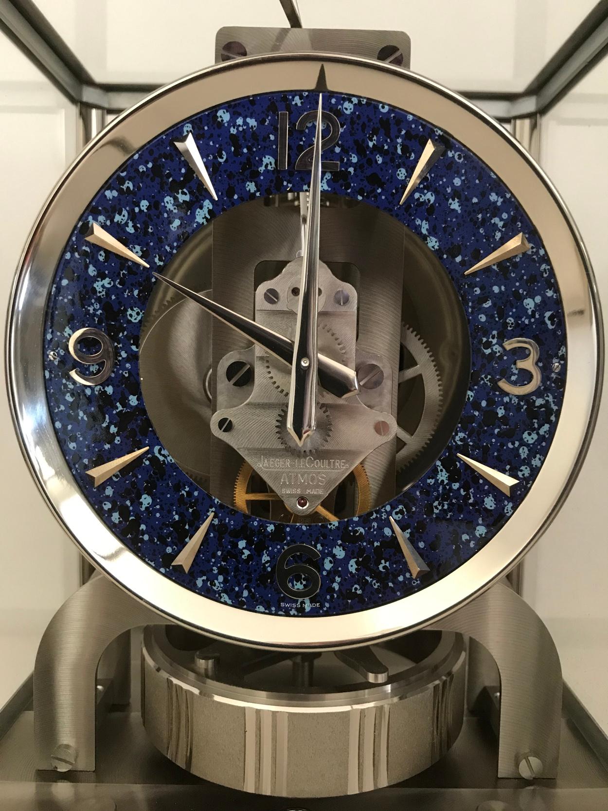 A rare Swiss Atmos Royale clock, circa 1974 the rhodium plated framed five glass body exposing the internal mechanism within, centered by a striking lapis style dial, with perpetual motion.

Serial number: 426914

Includes the original manual.