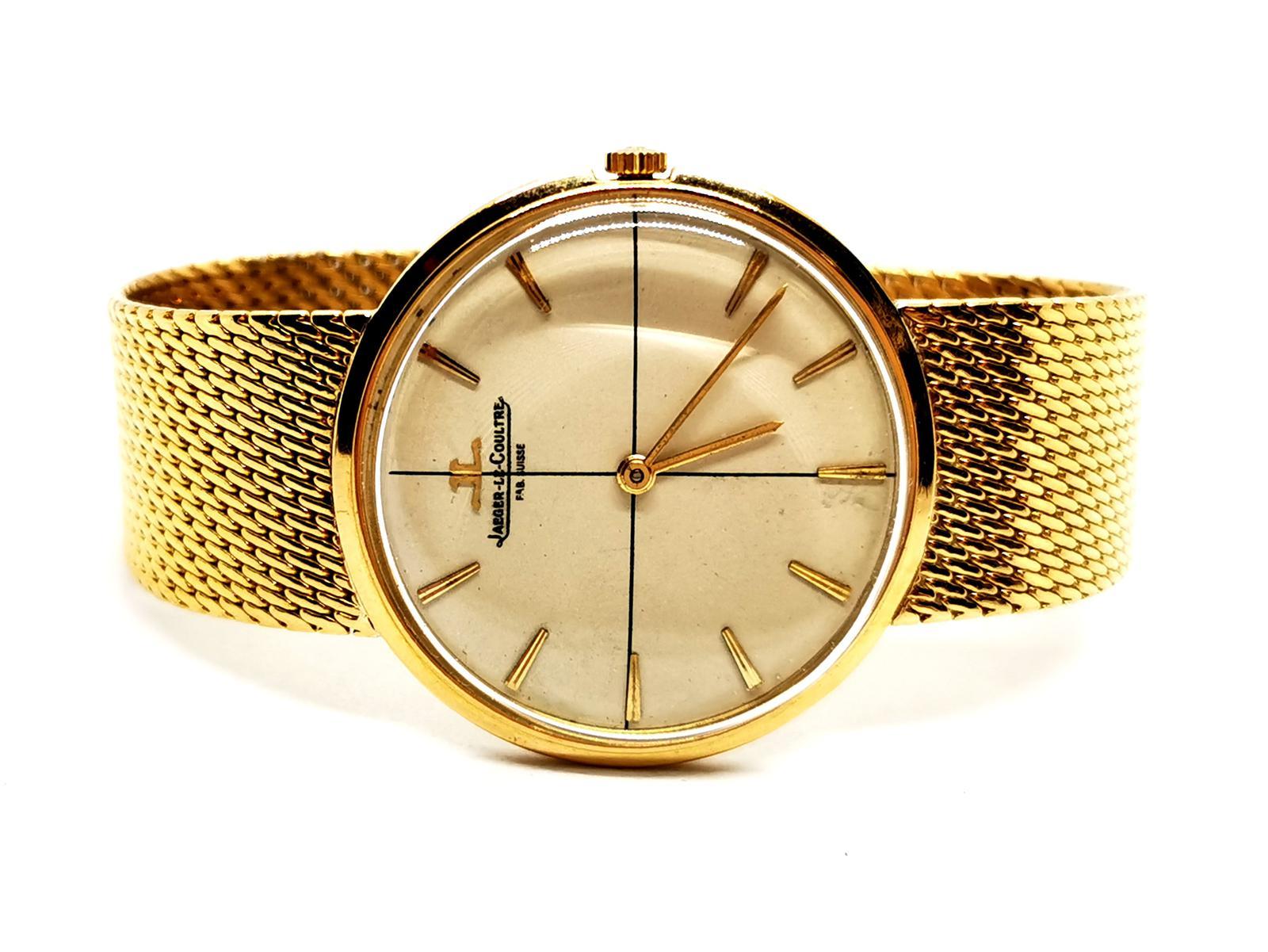 Women's watch. signed by Jaeger Lecoultre. in yellow gold 750 thousandths (18 carats). mechanical movement. round case 33mm. beige dial. golden hands. gold bar indexes. Milanese mesh bracelet. ratchet clasp with double 8 safety. plexiglass glass.